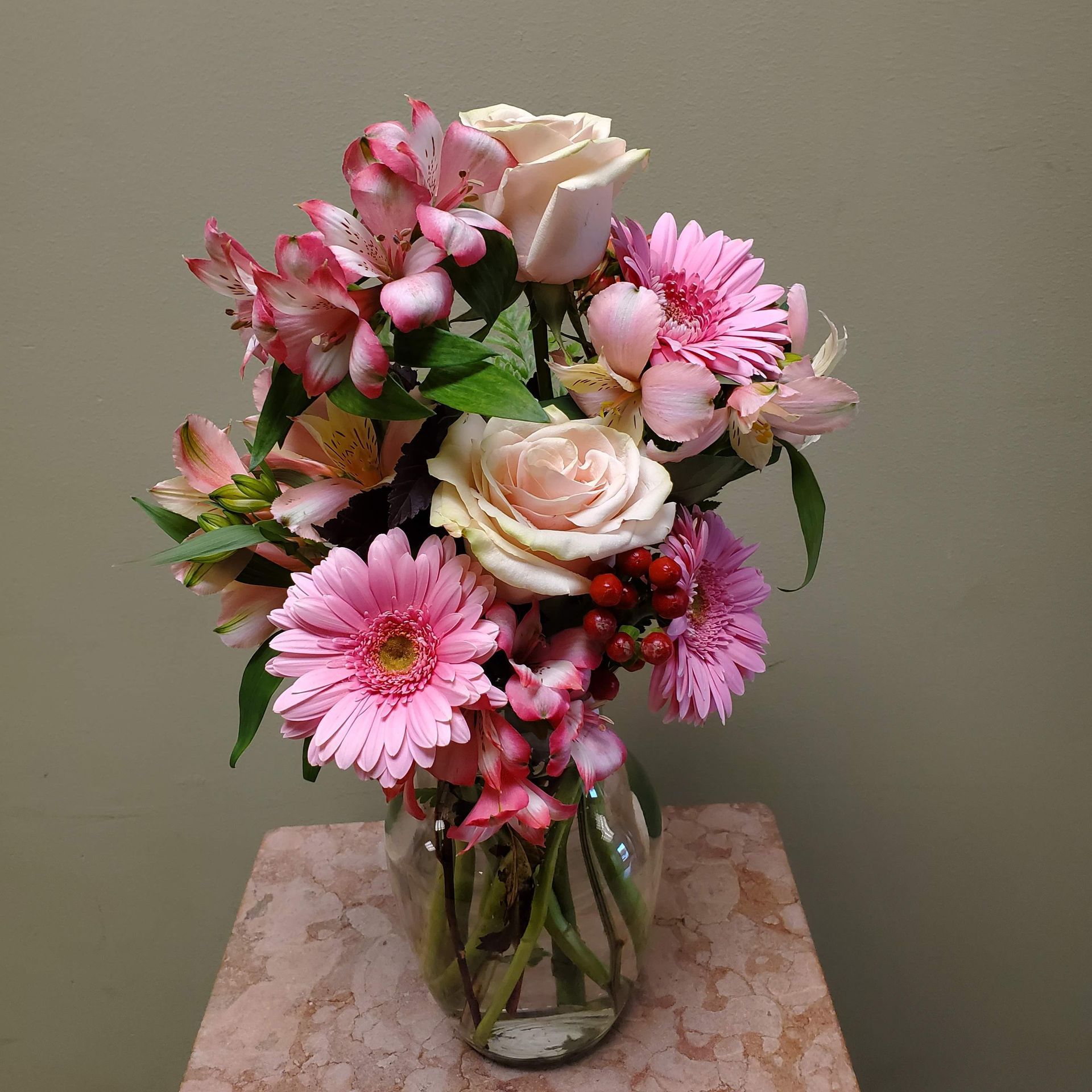 A vase filled with flowers is sitting on a table.
