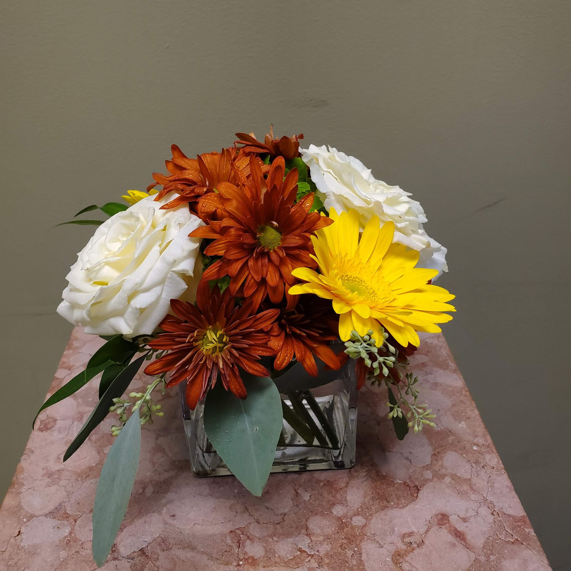 A vase filled with flowers is sitting on a table.