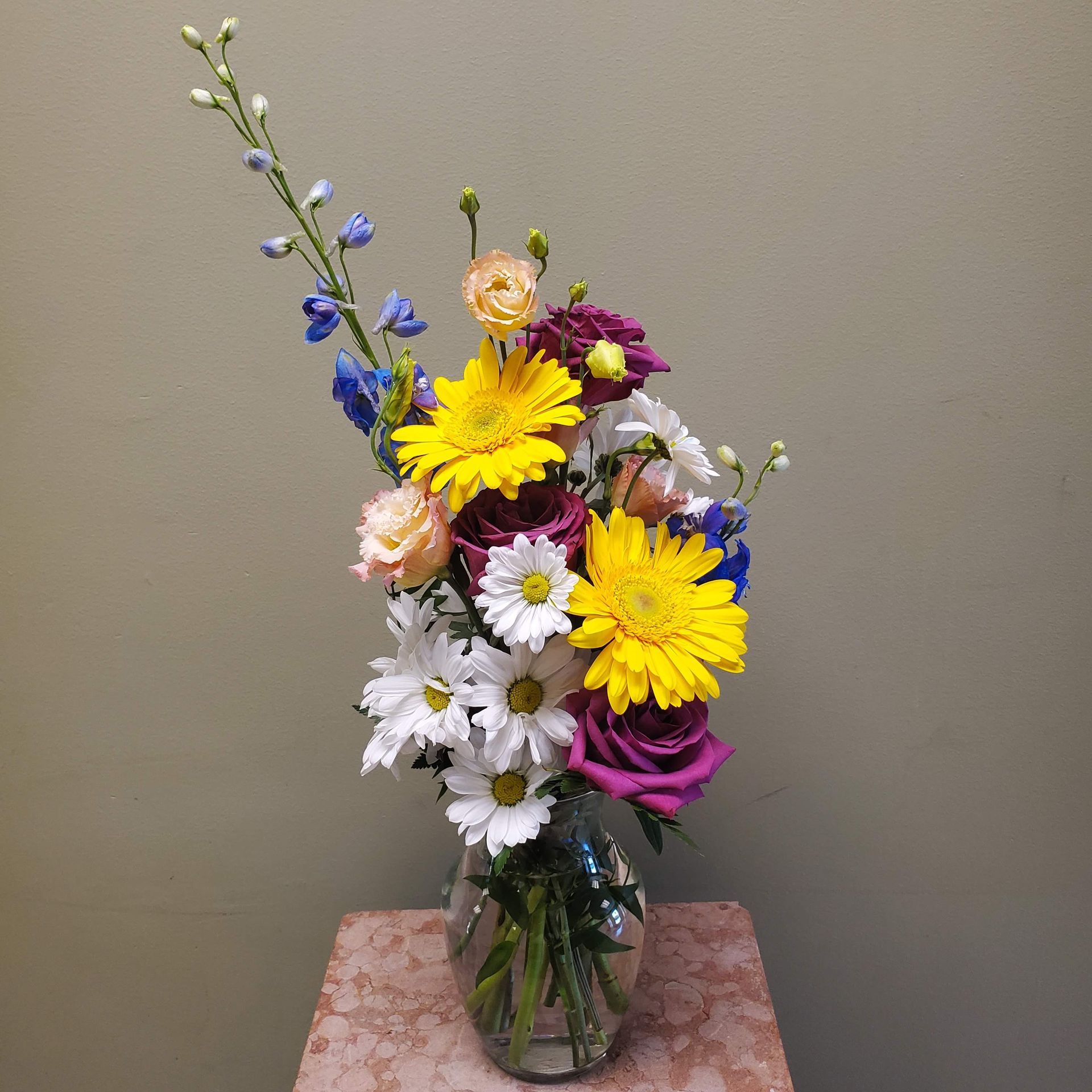 A vase filled with flowers is sitting on a table.