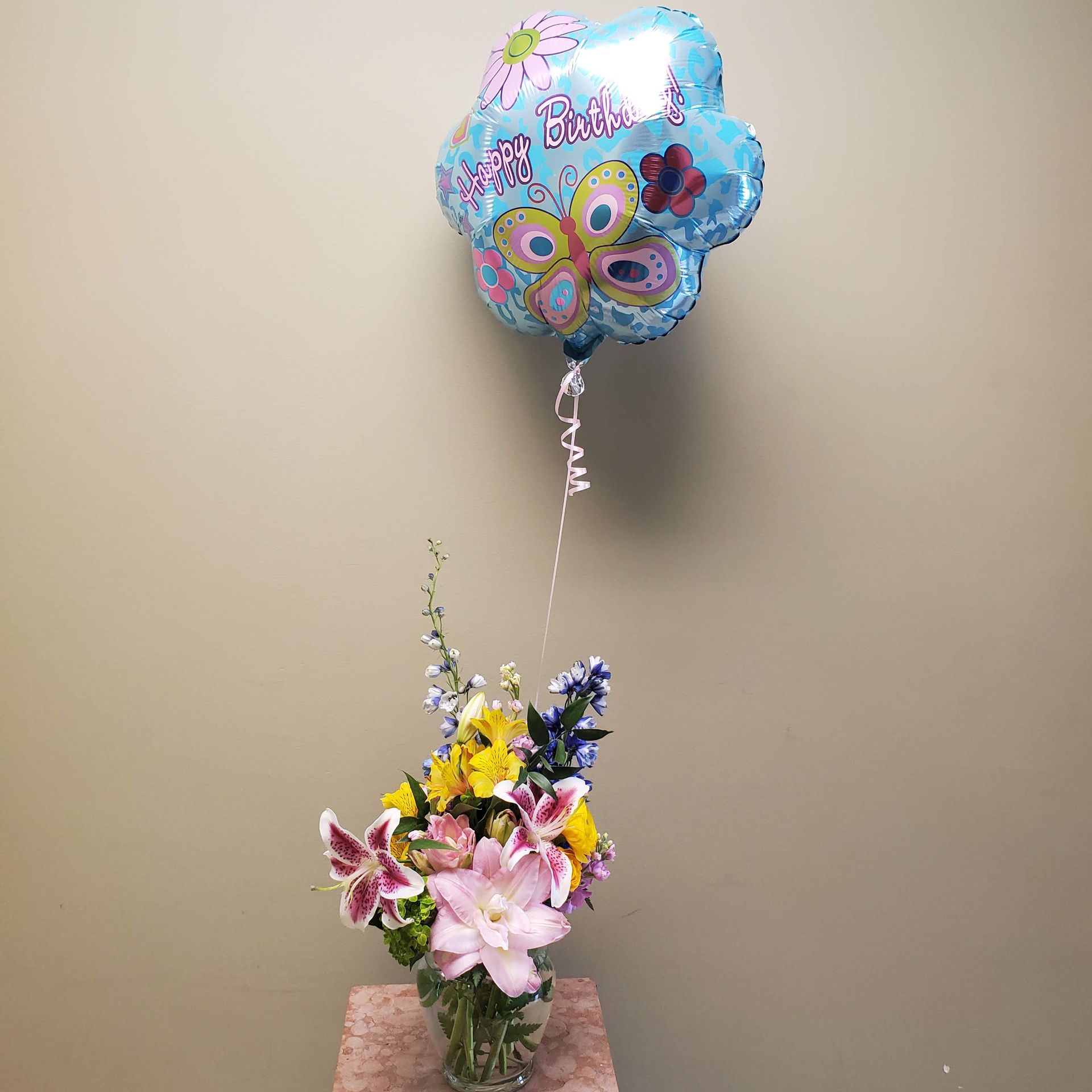 A vase filled with flowers is sitting on a table.