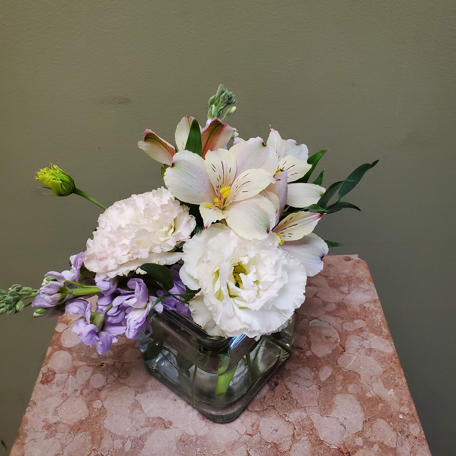 A vase filled with flowers is sitting on a table.