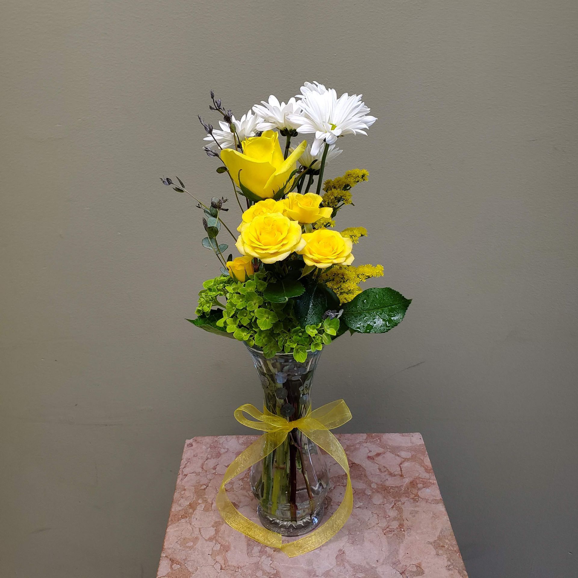A vase filled with flowers is sitting on a table.