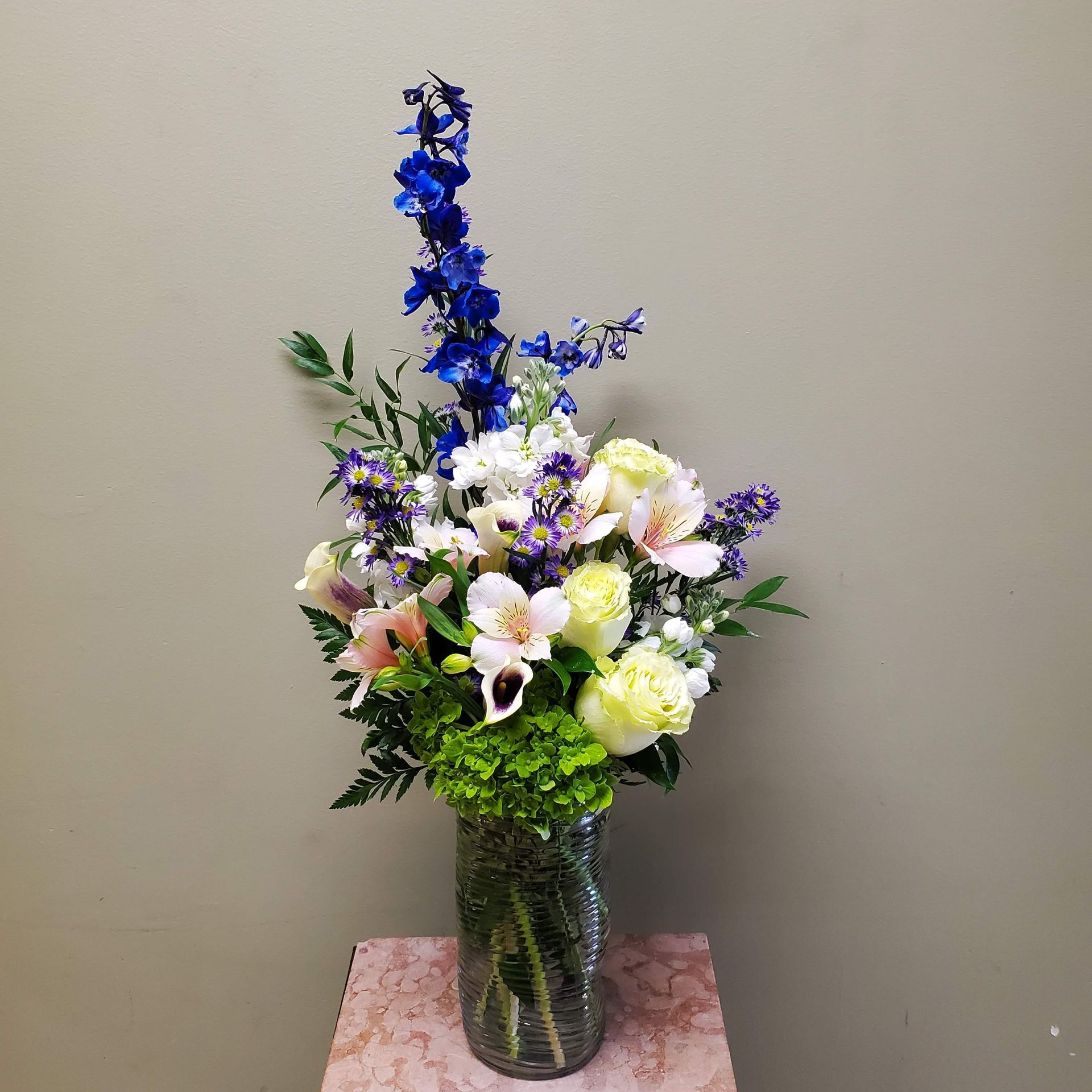 A vase filled with flowers is sitting on a table.