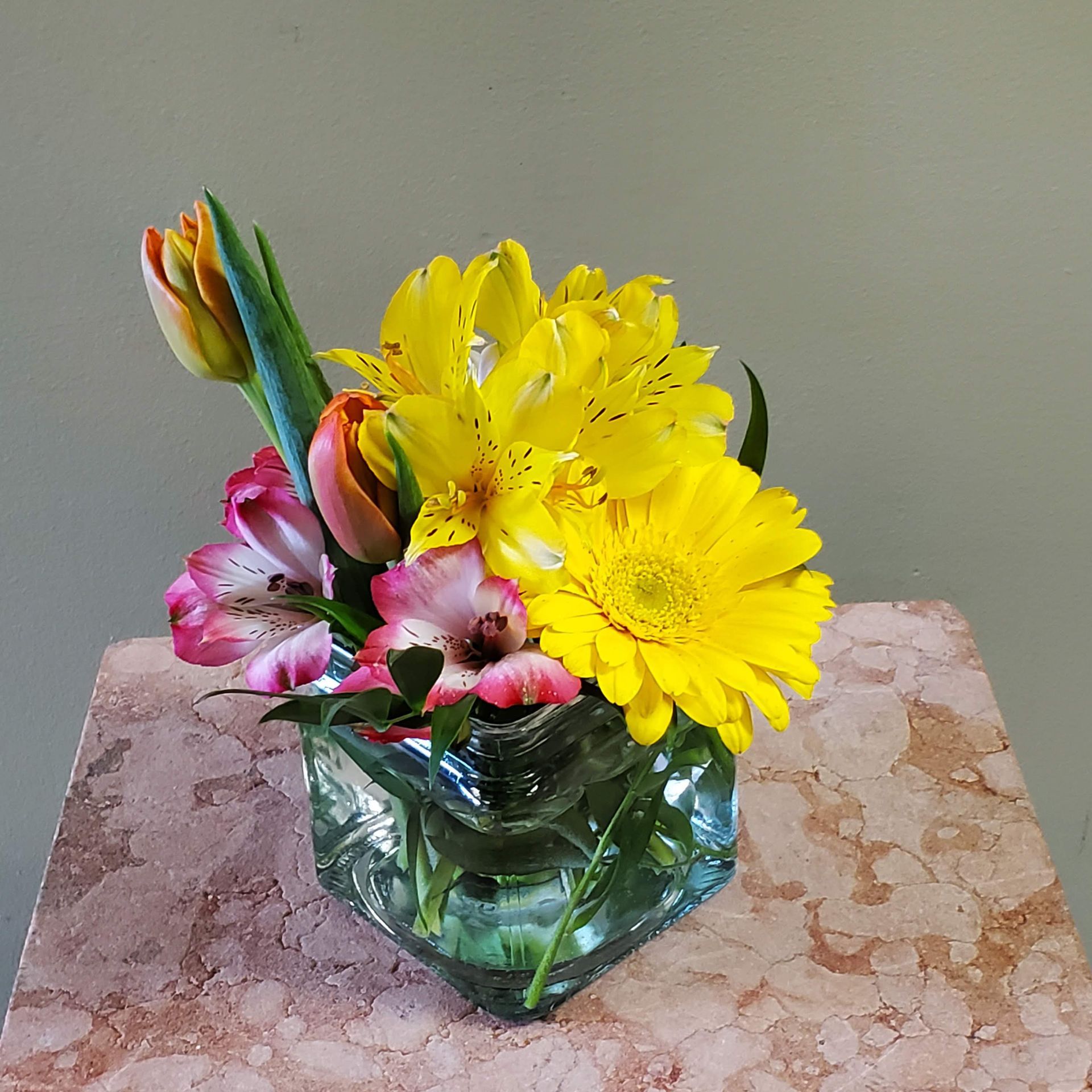 A vase filled with flowers is sitting on a table.