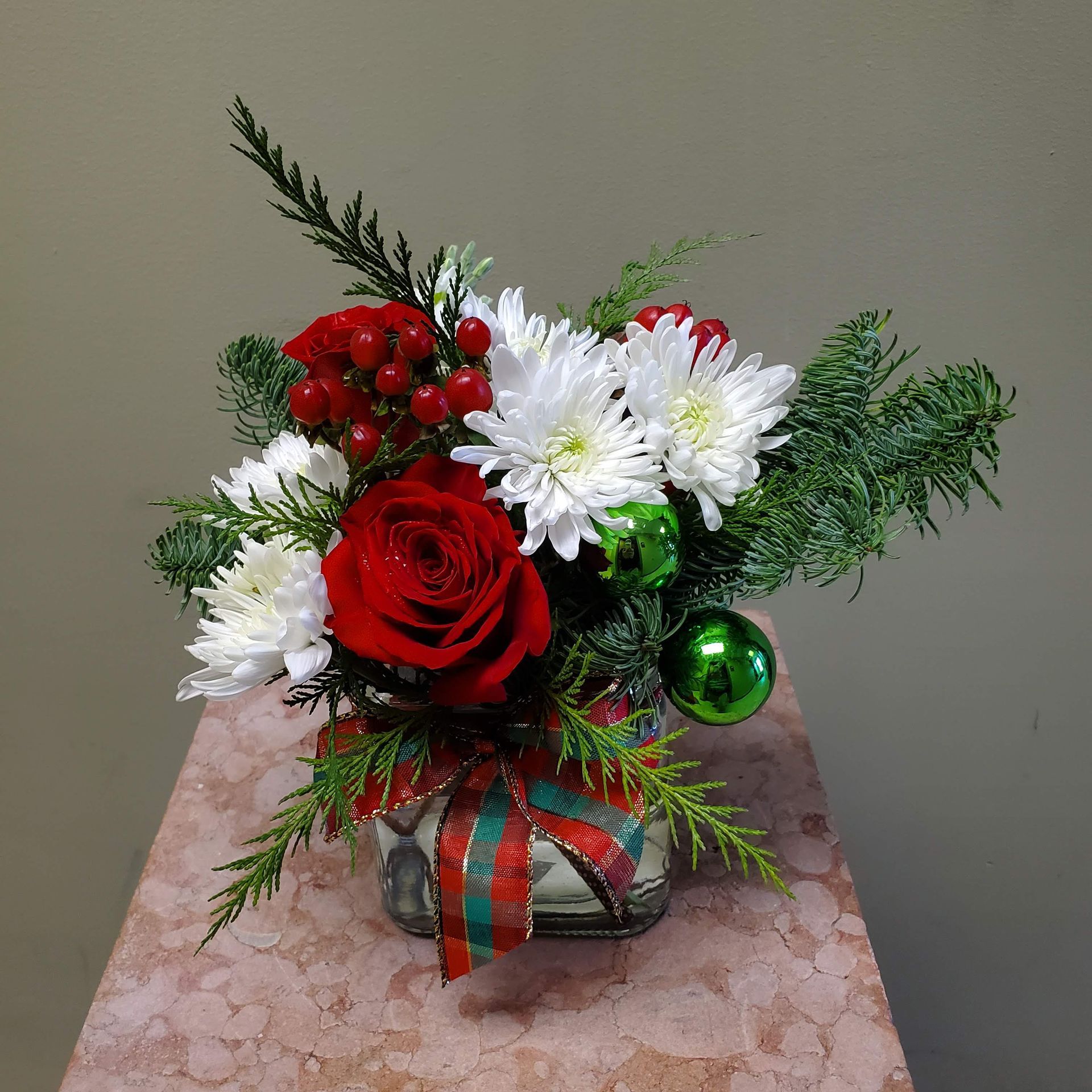A vase filled with flowers is sitting on a table.