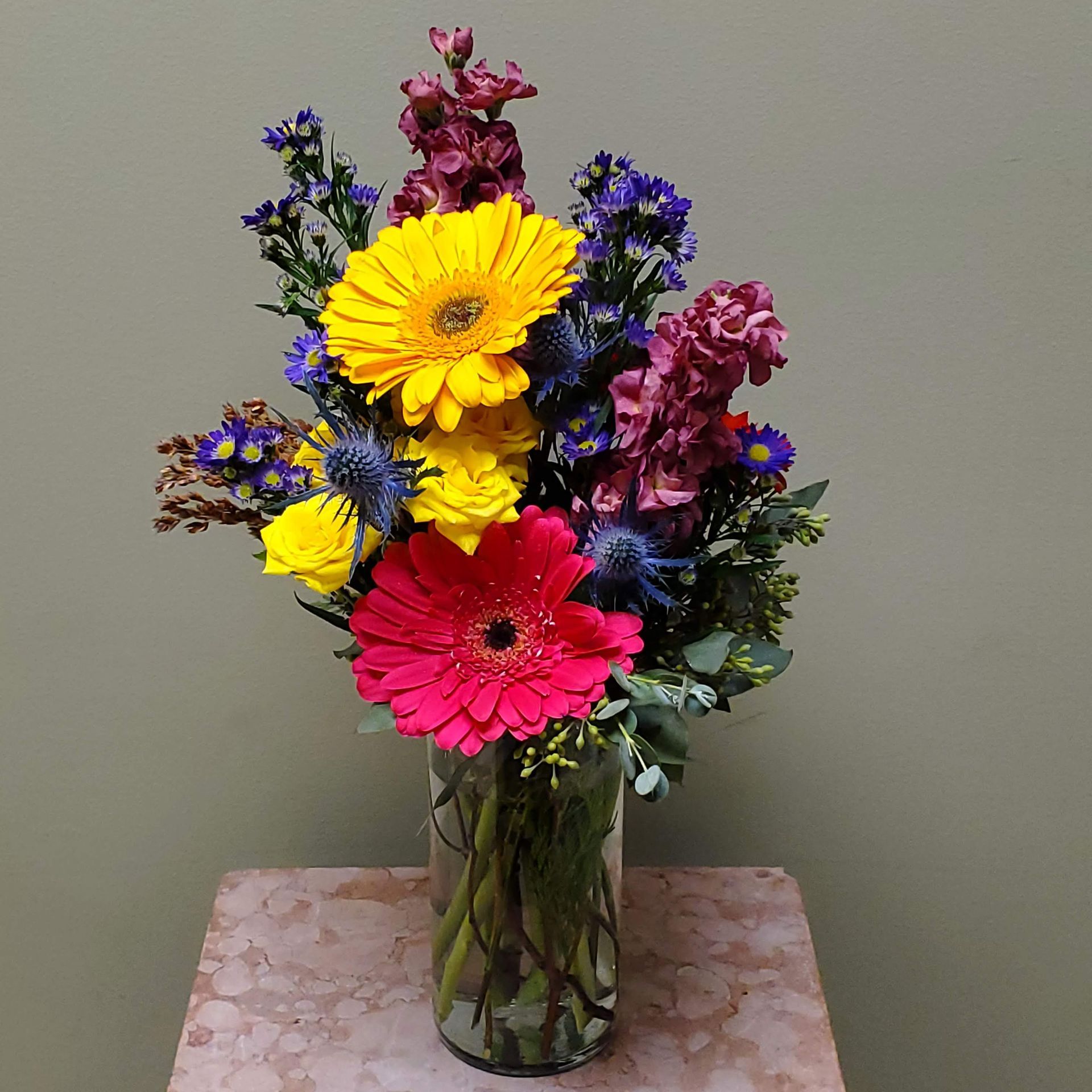 A vase filled with flowers is sitting on a table.