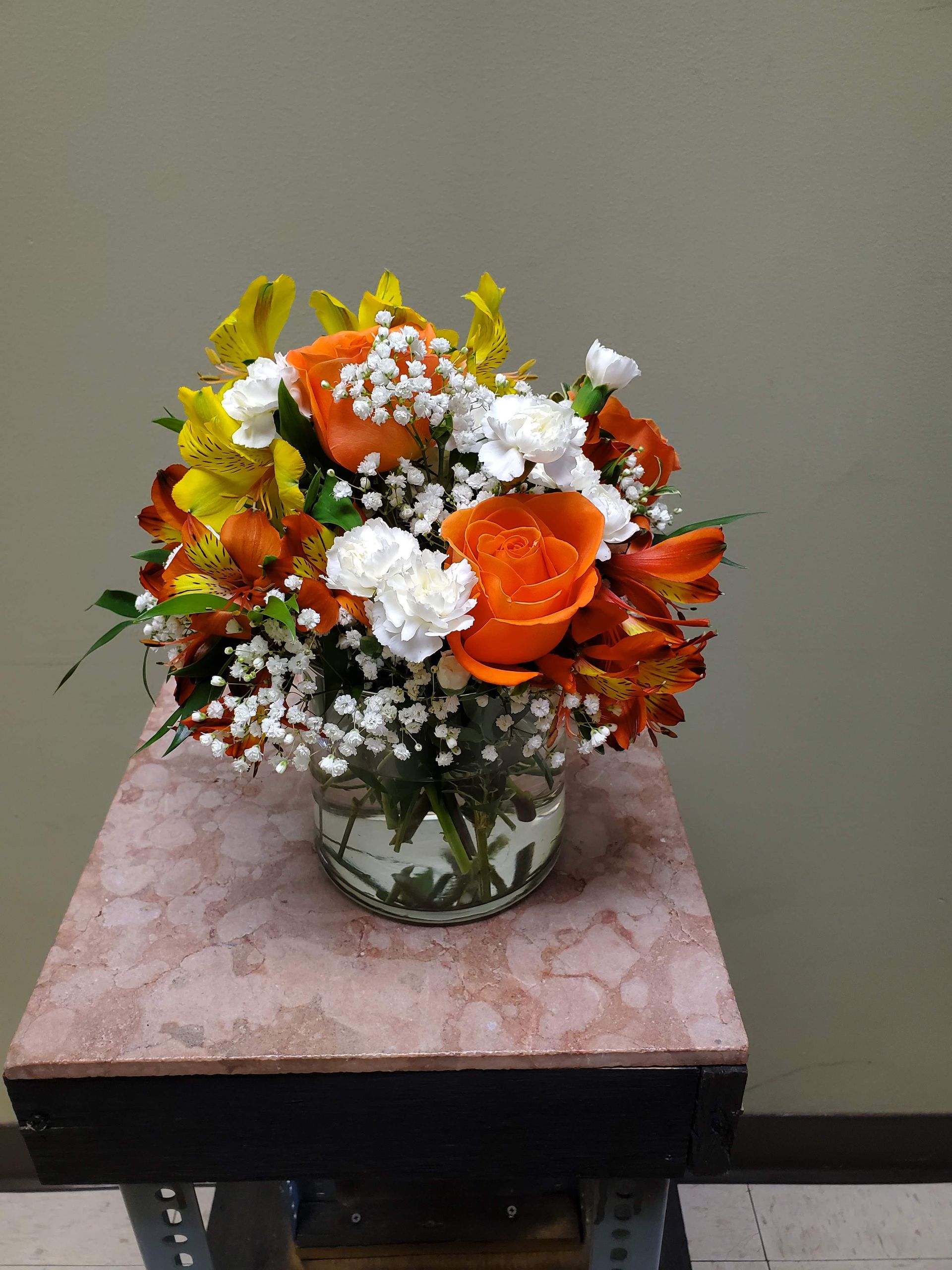 A vase filled with flowers is sitting on a table.