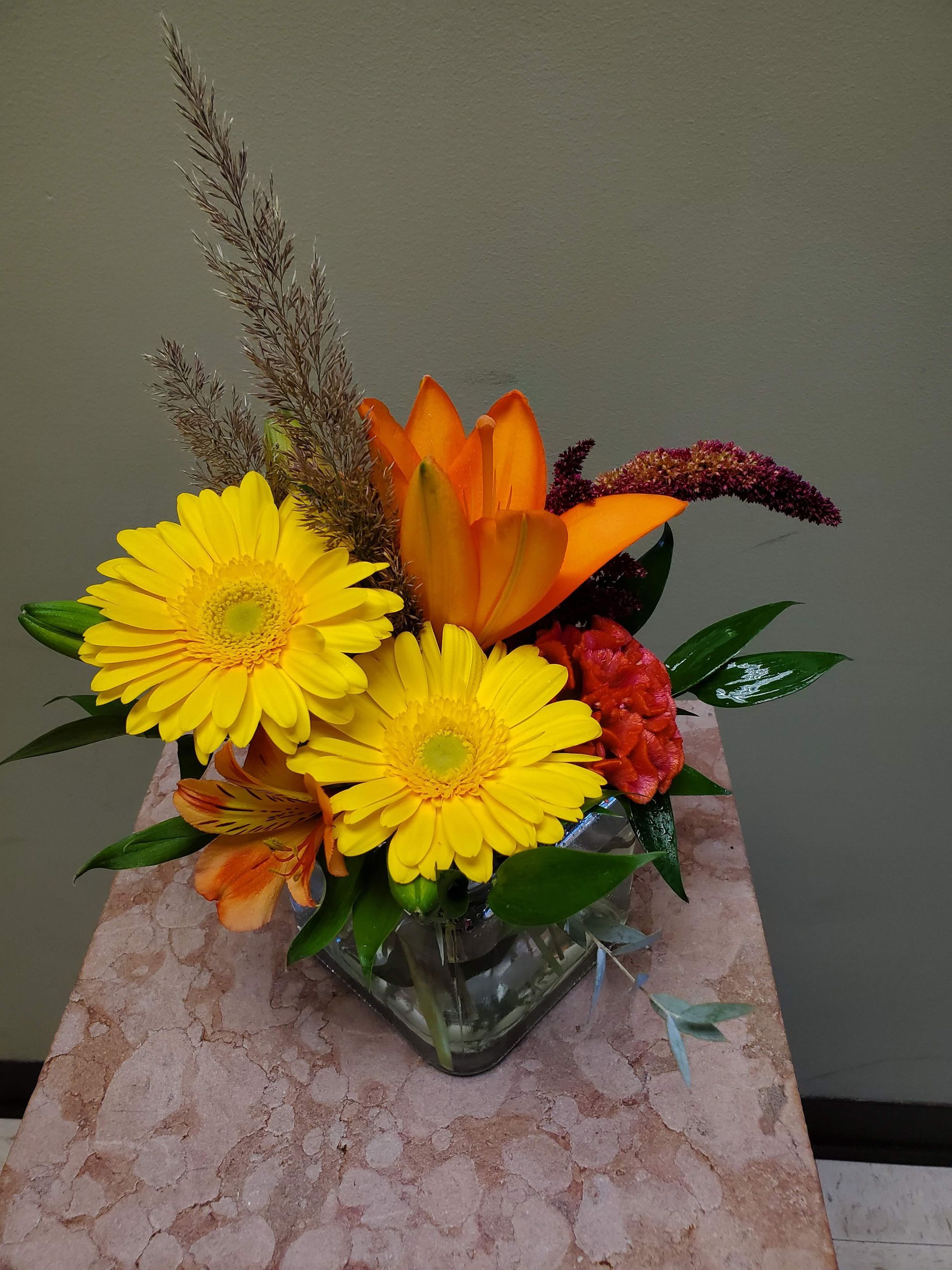 A vase filled with flowers is sitting on a table.