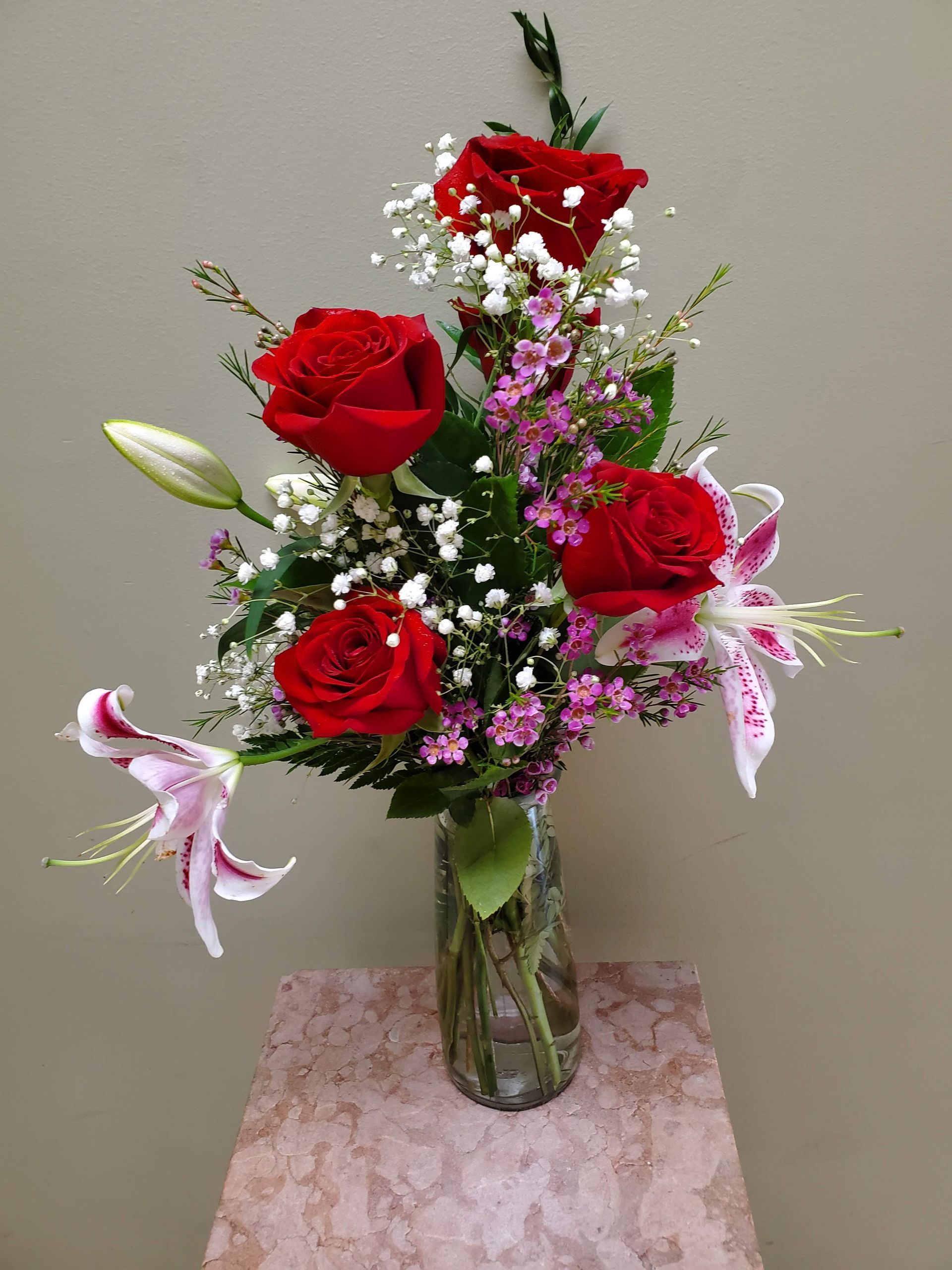 A vase filled with flowers is sitting on a table.