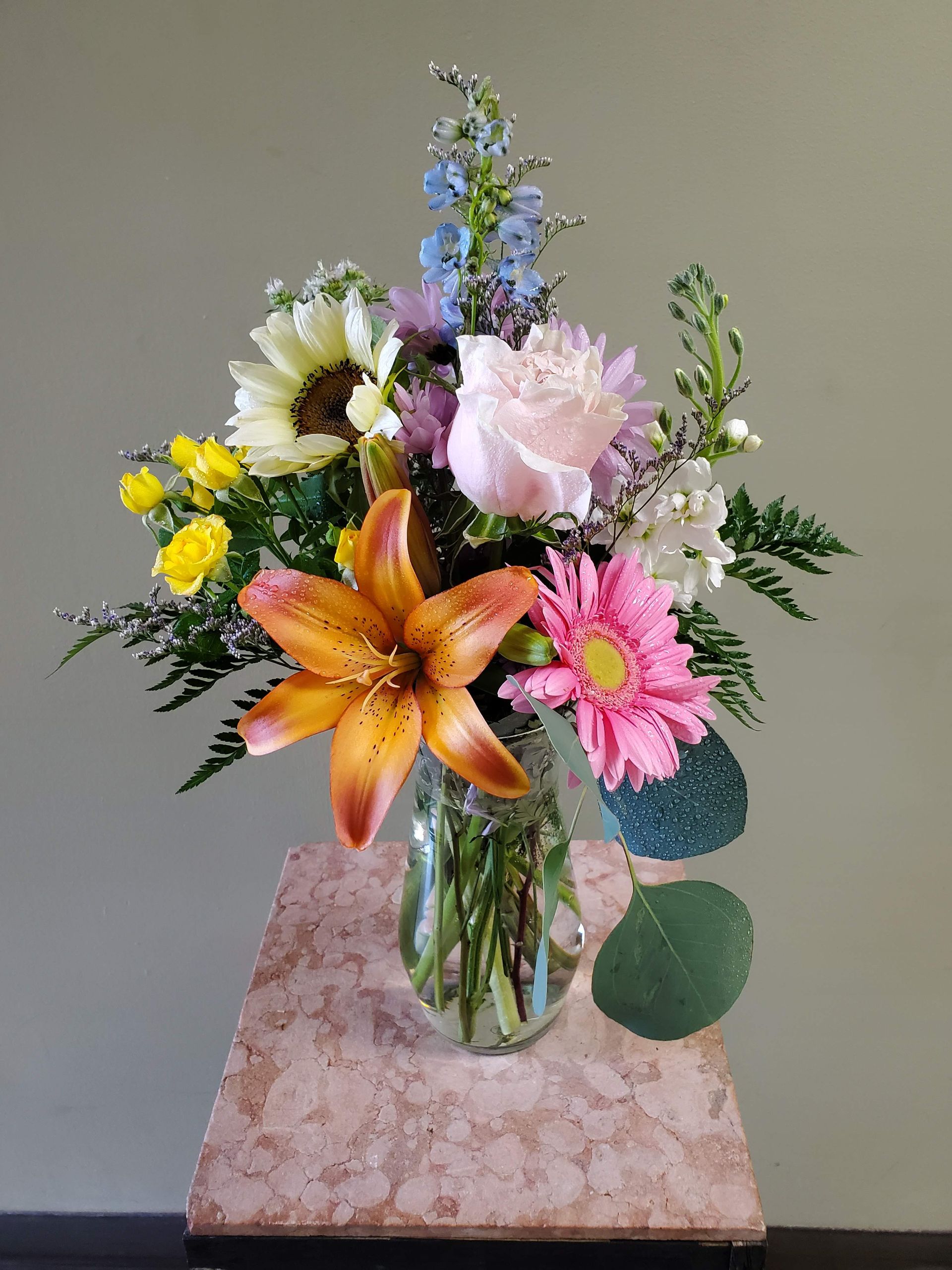 A vase filled with flowers is sitting on a table.