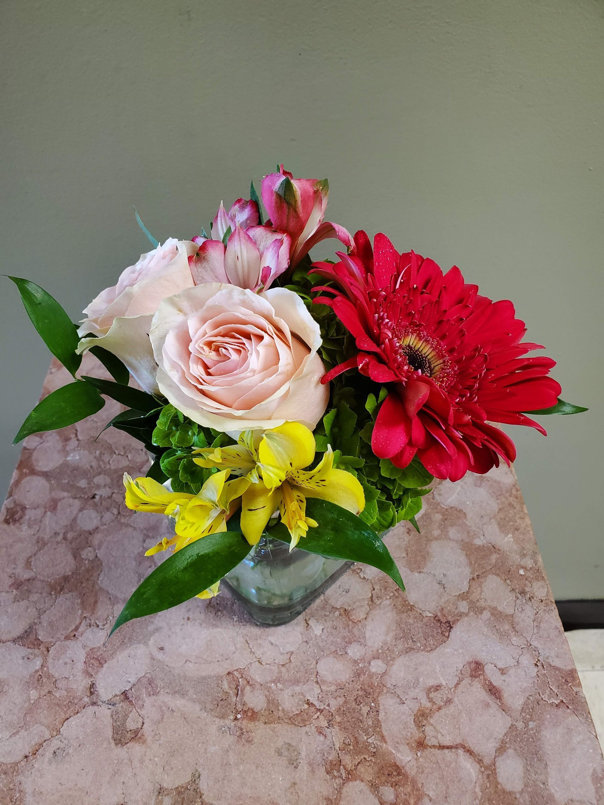 A vase filled with flowers is sitting on a table.