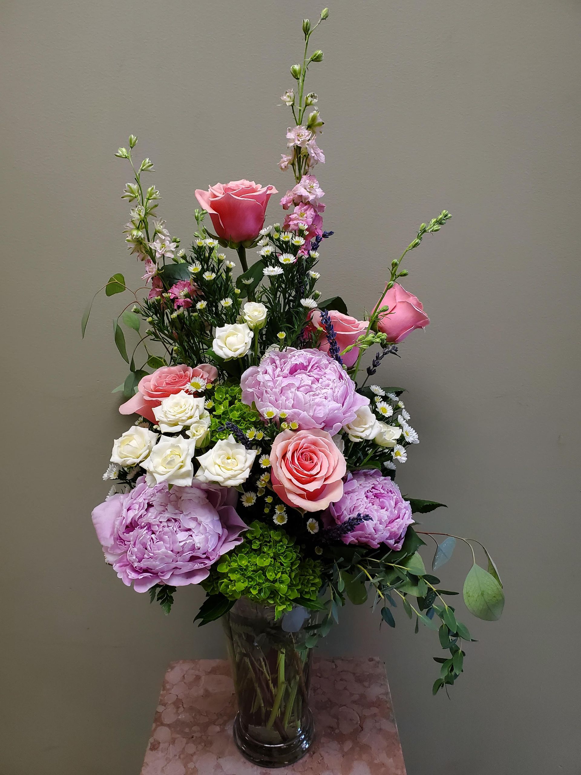 A vase filled with flowers is sitting on a table.