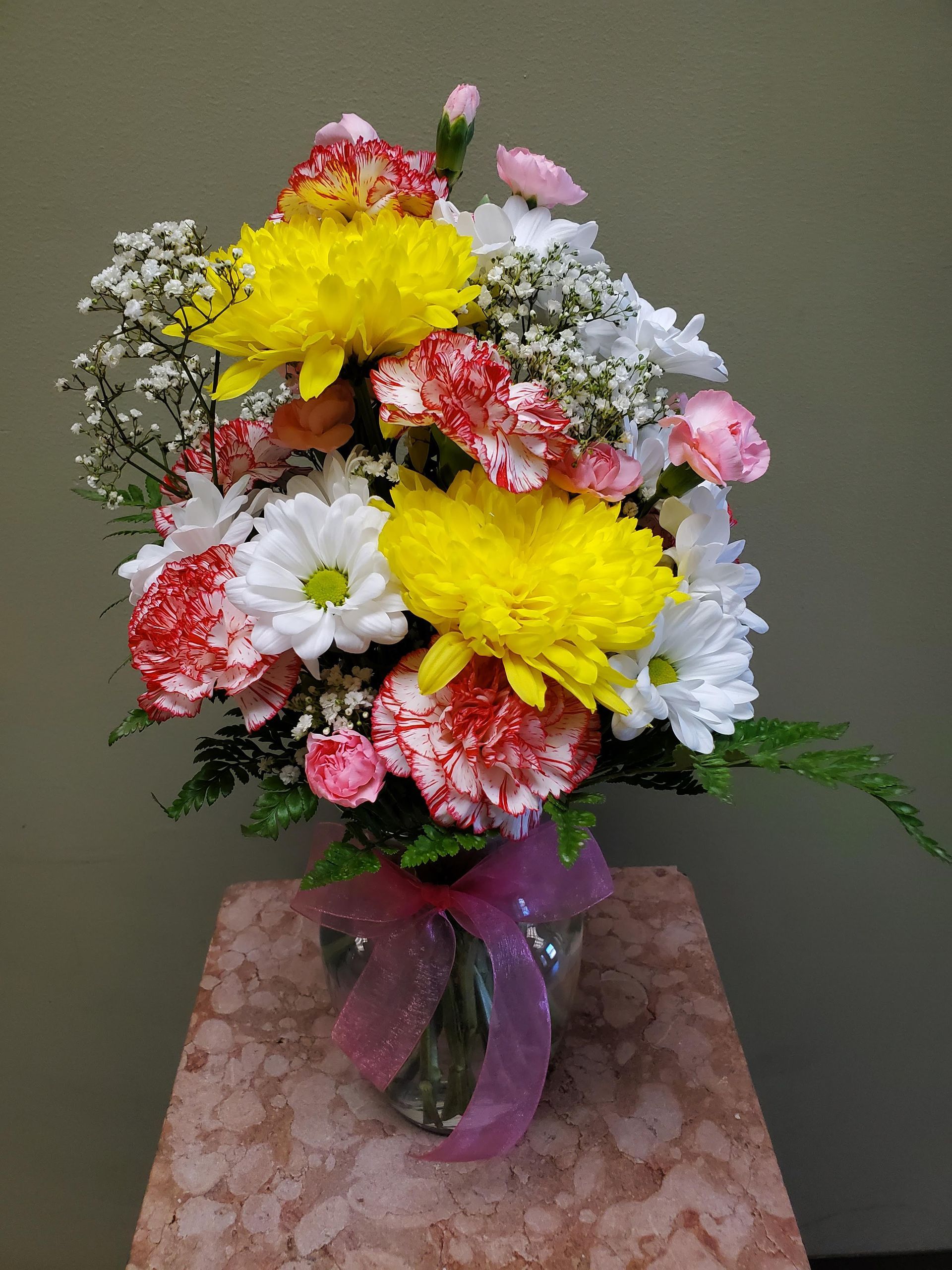 A vase filled with flowers is sitting on a table.