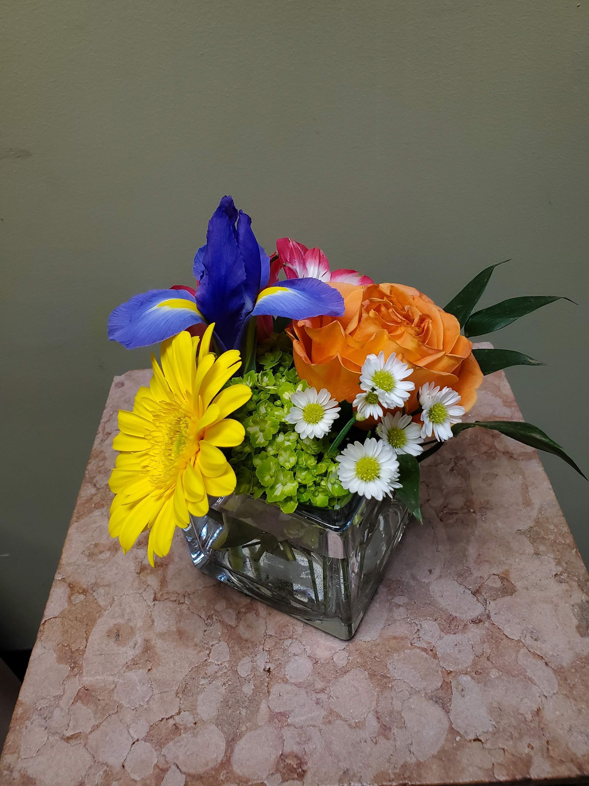 A vase filled with flowers is sitting on a table.