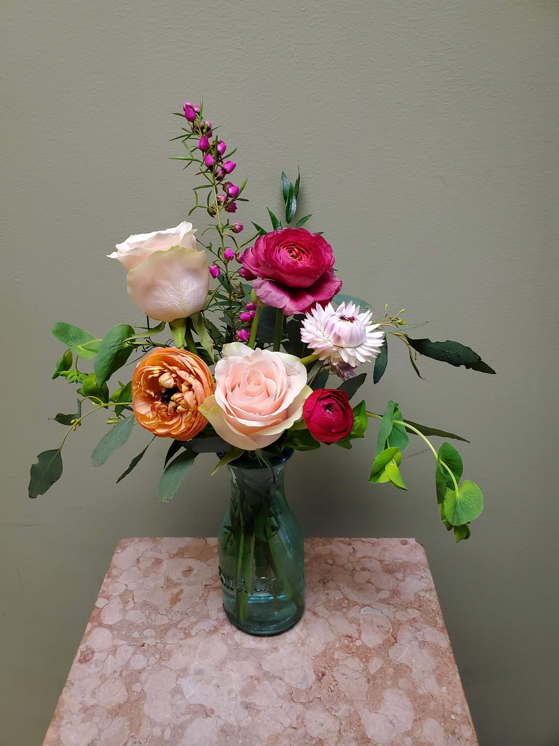 A vase filled with flowers is sitting on a table.