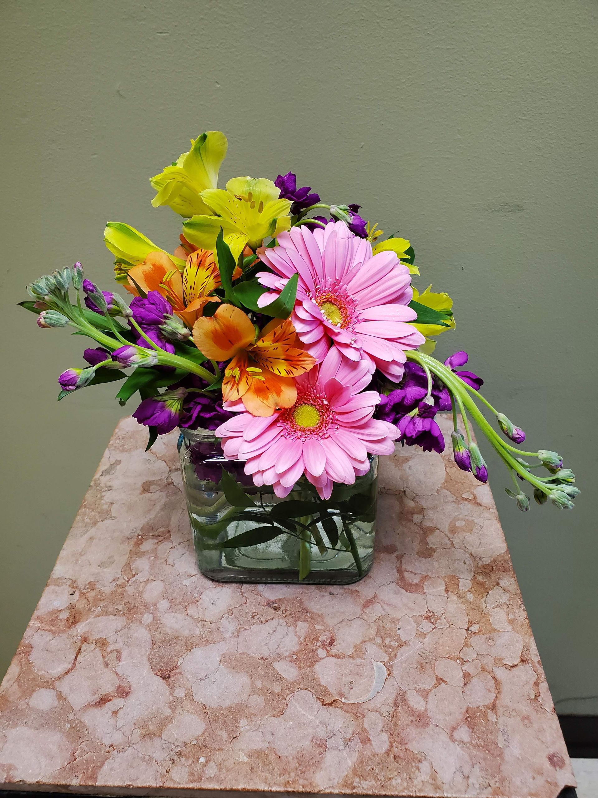 A vase filled with flowers is sitting on a table.