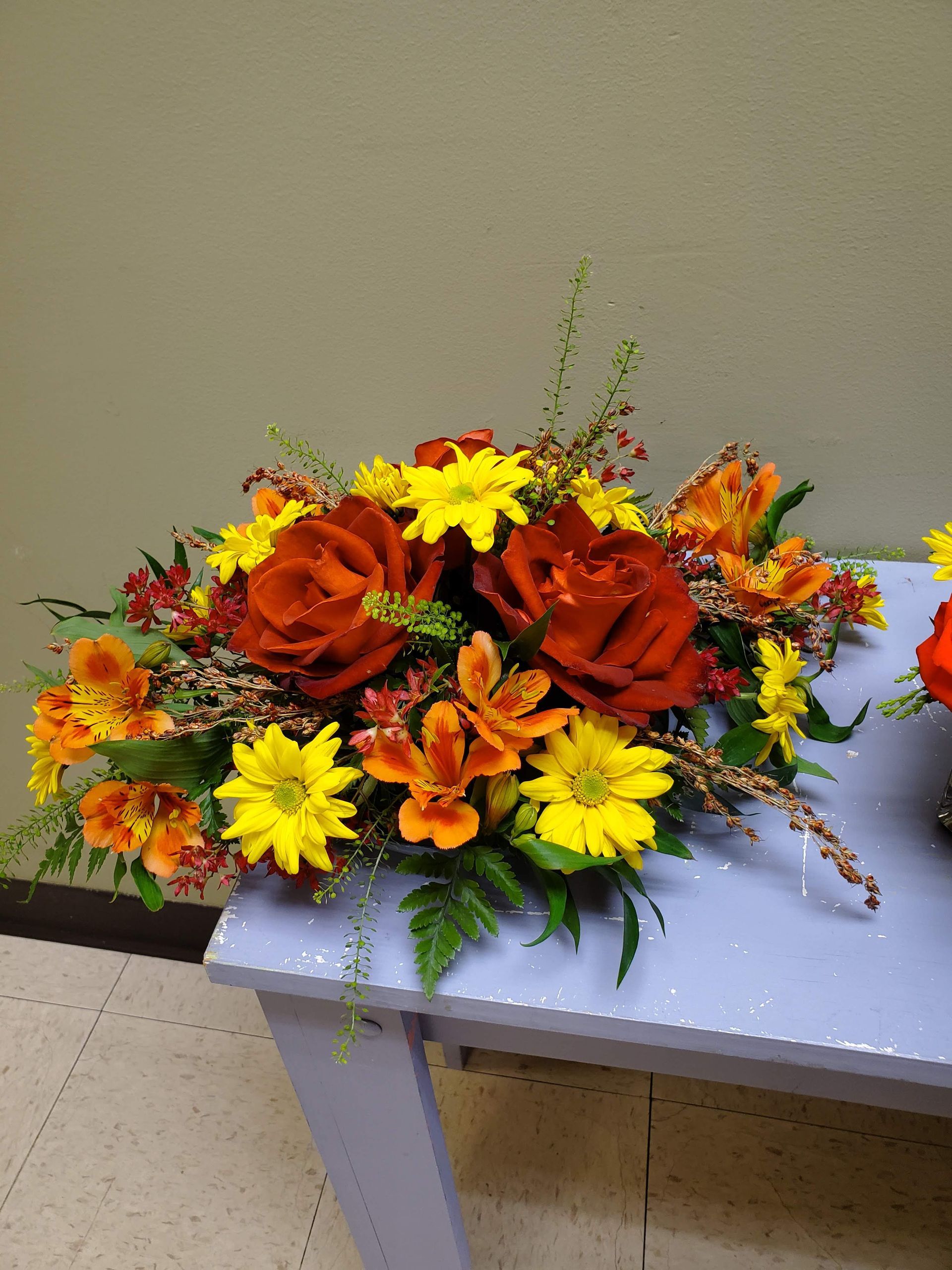 A vase filled with flowers is sitting on a table.