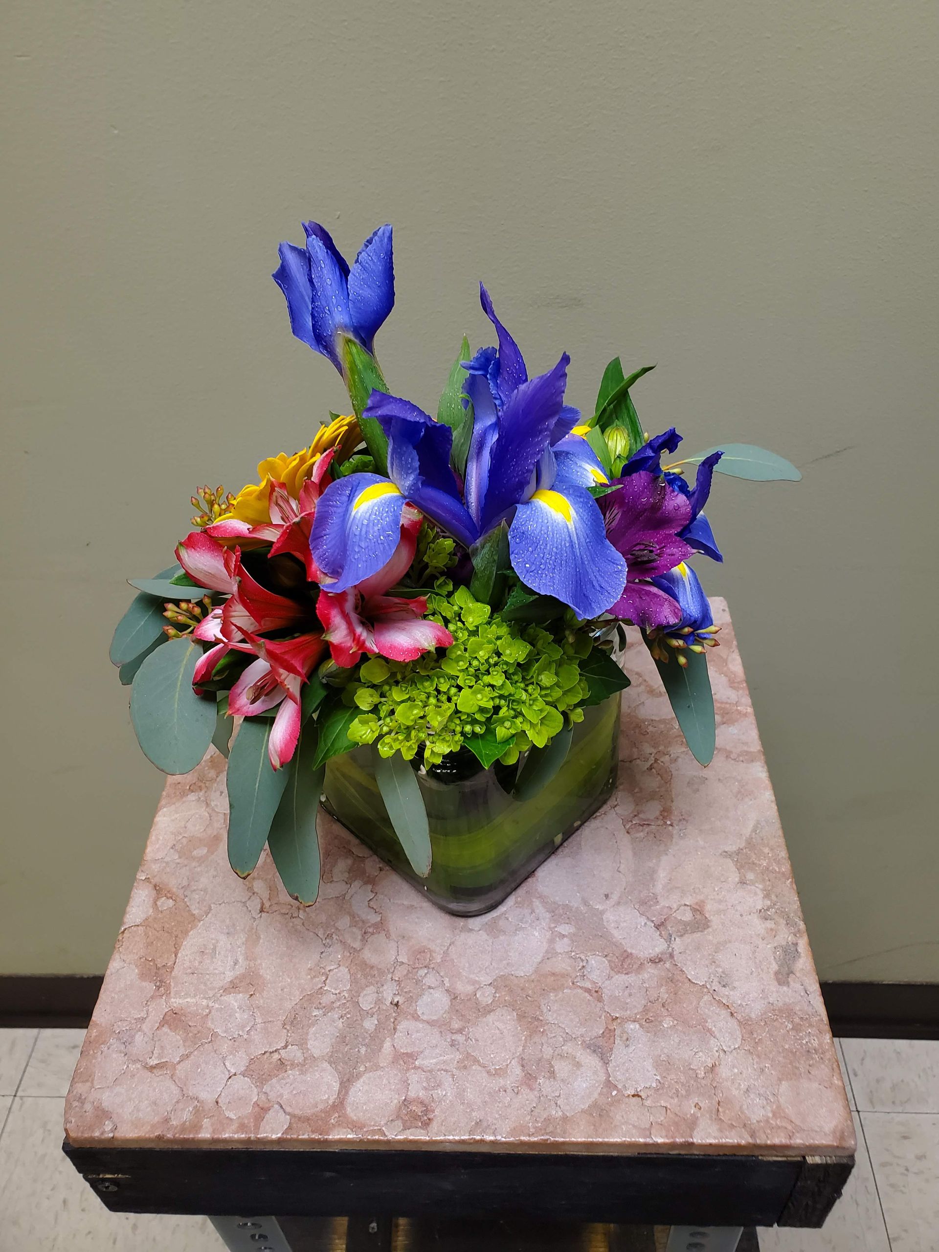 A vase filled with flowers is sitting on a table.