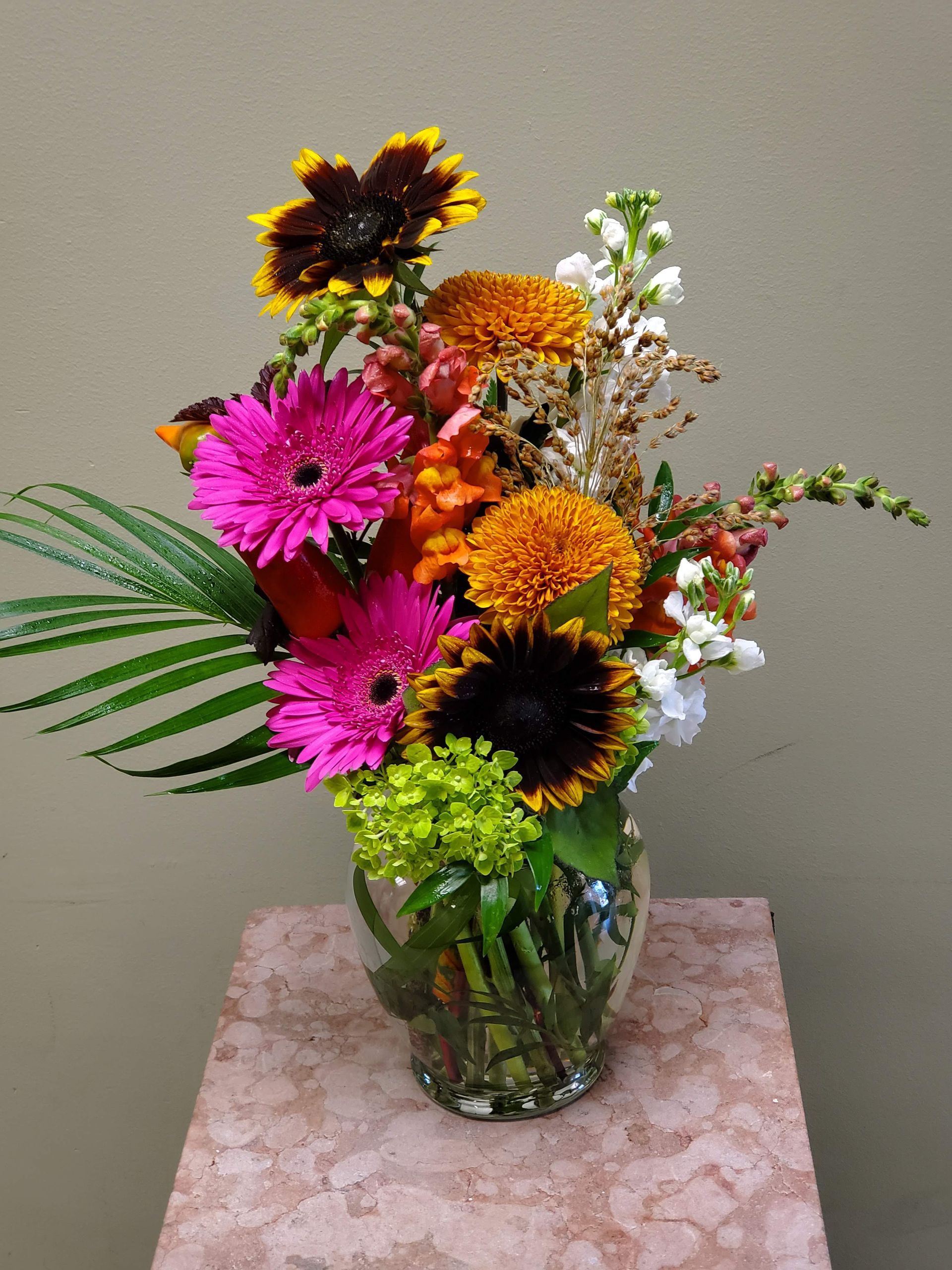 A vase filled with flowers is sitting on a table.