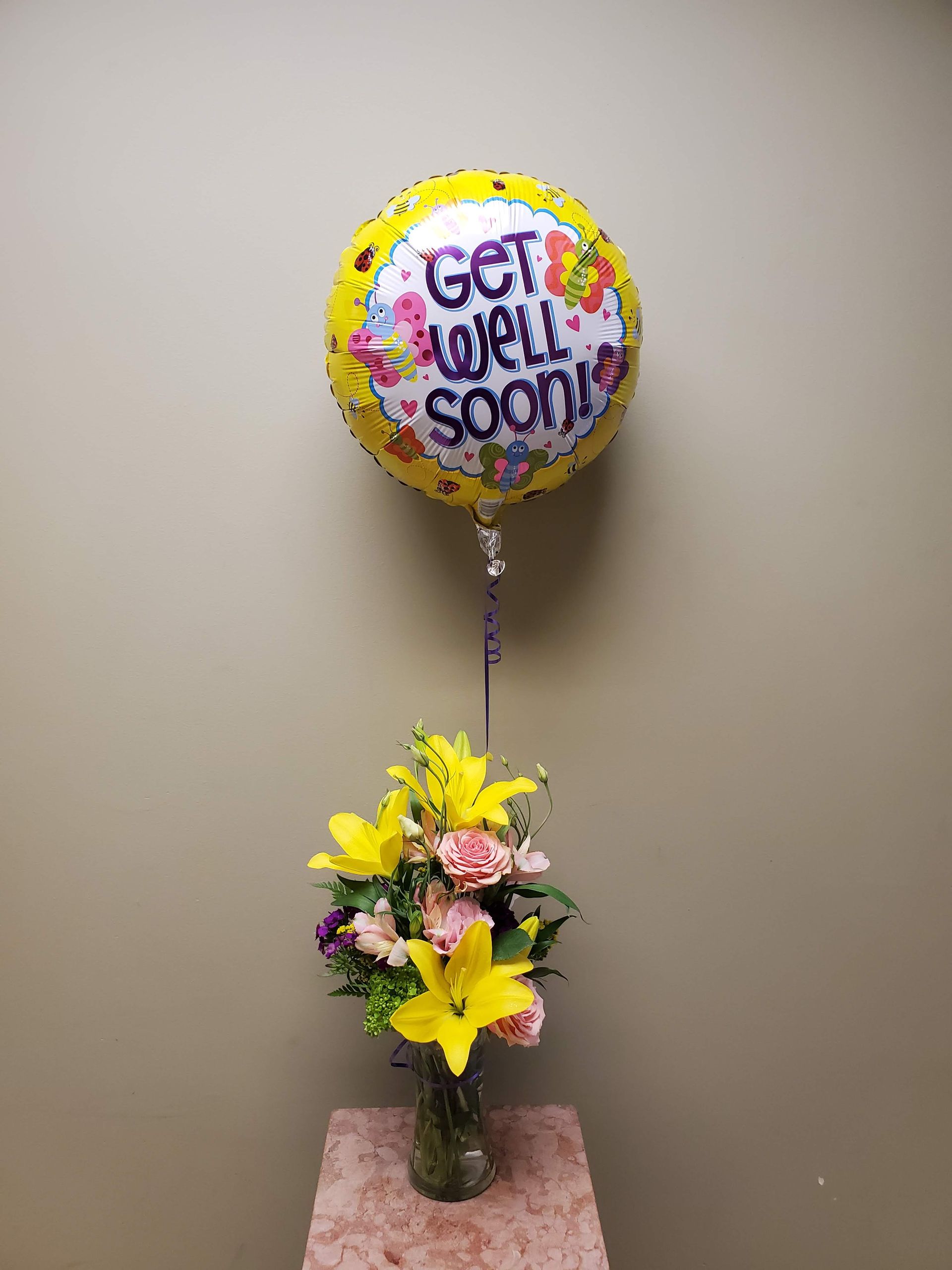 A vase filled with flowers is sitting on a table.
