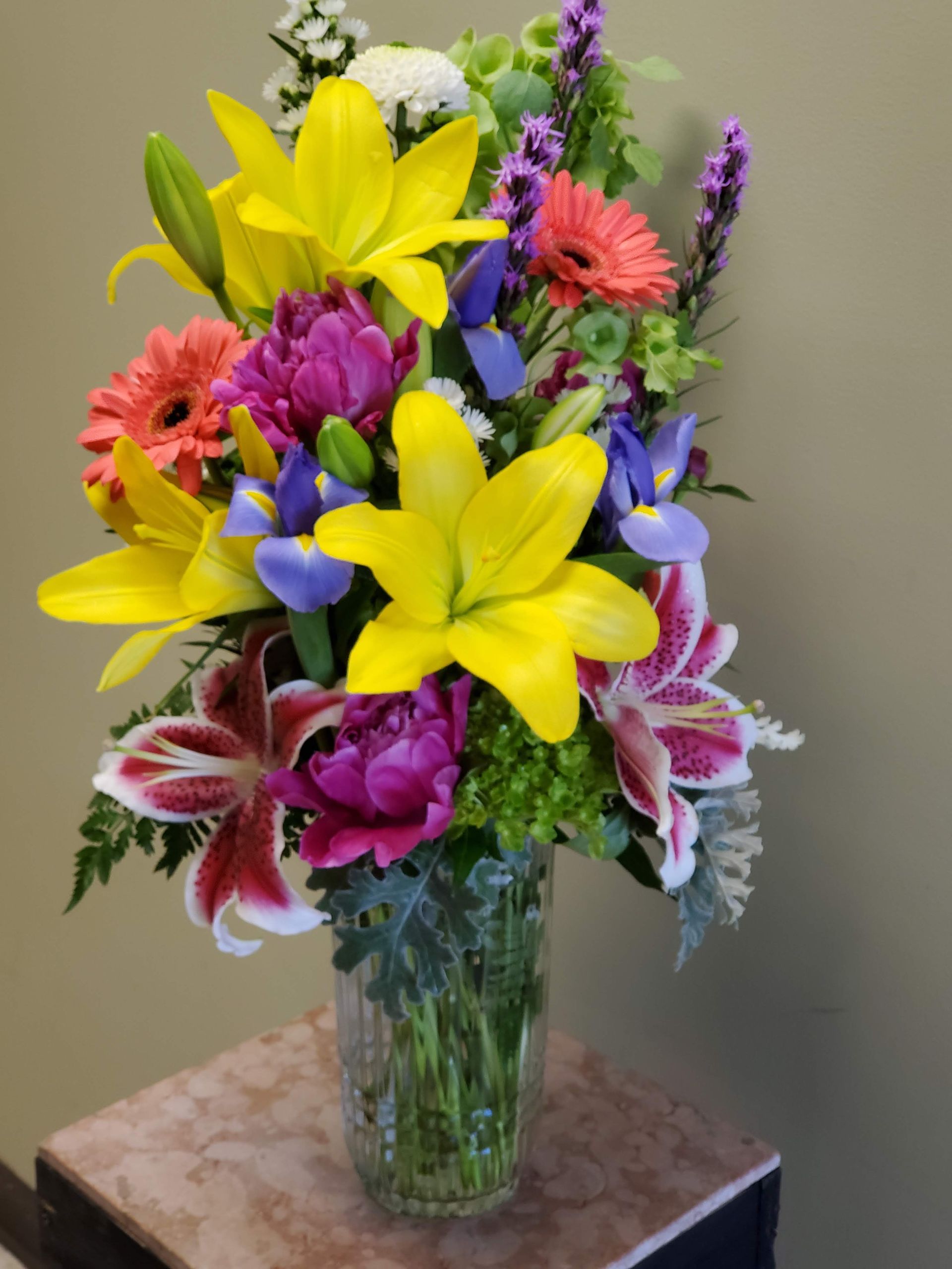 A vase filled with flowers is sitting on a table.