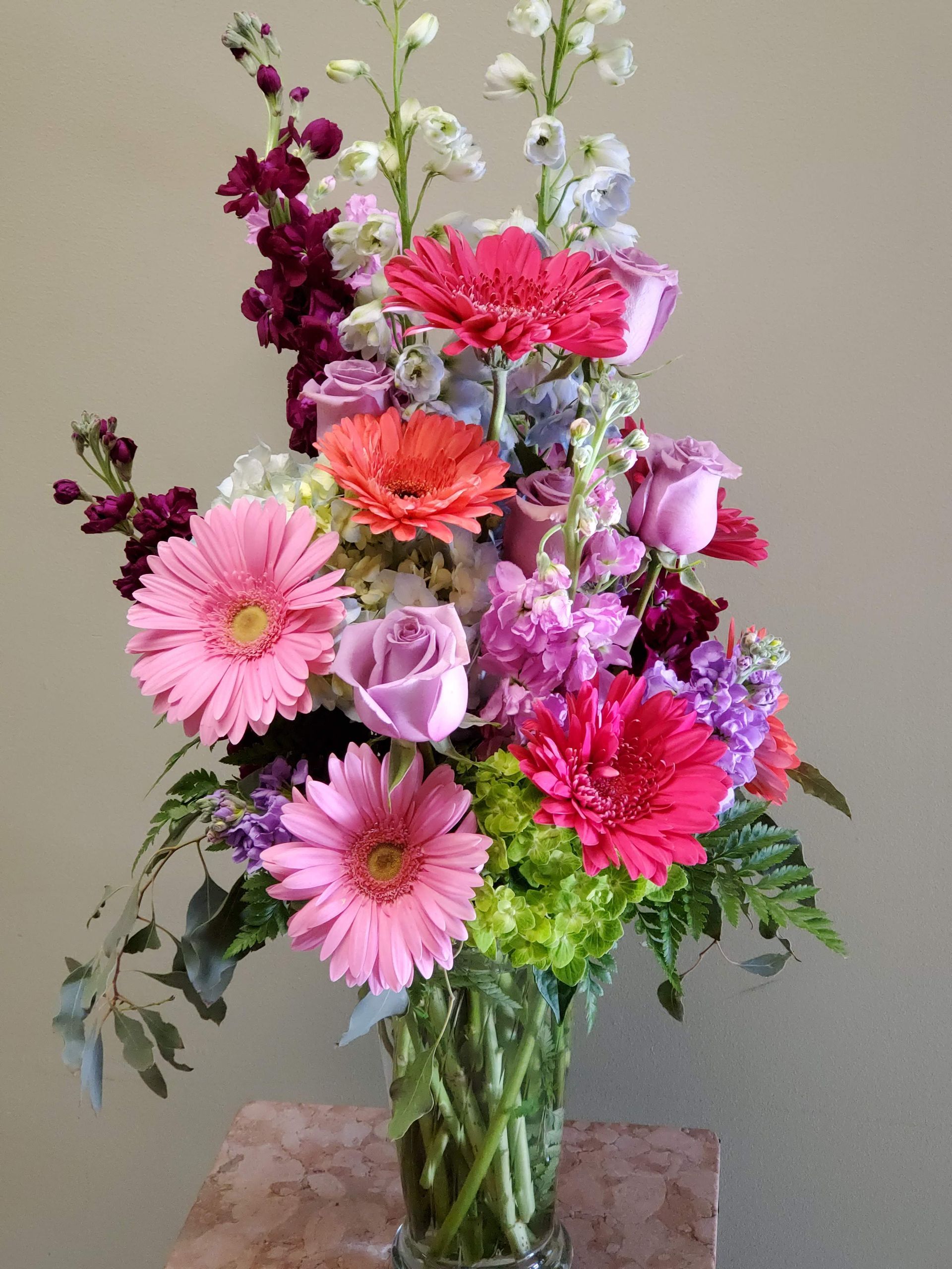 A vase filled with flowers is sitting on a table.