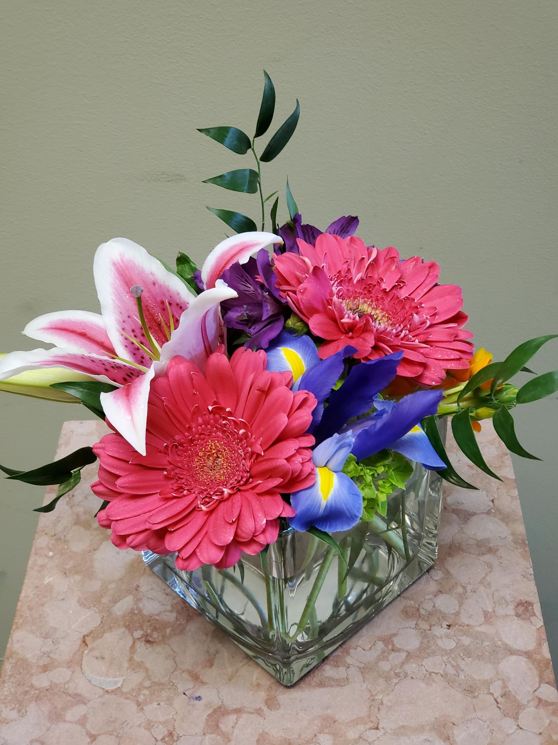 A vase filled with flowers is sitting on a table.