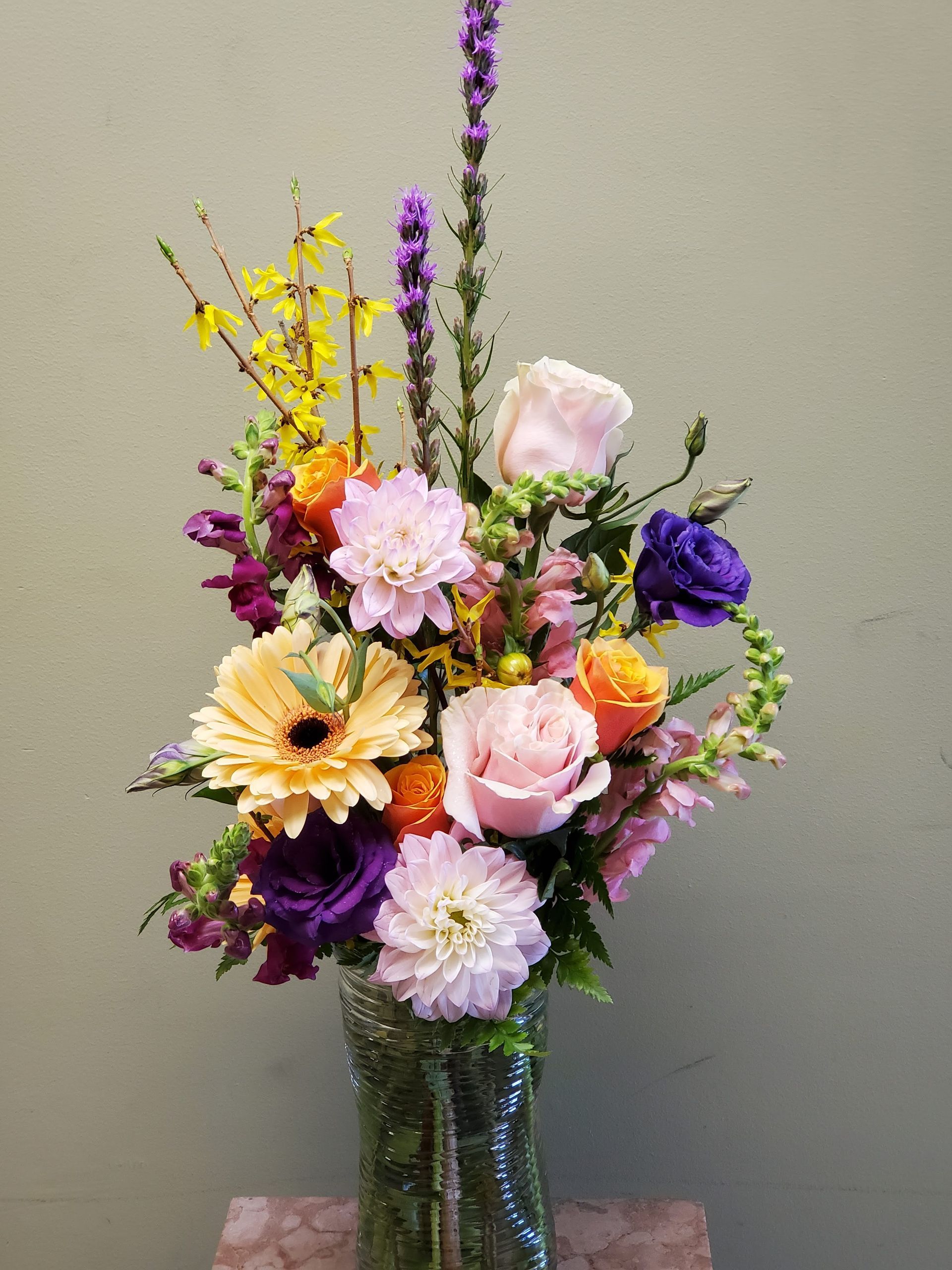 A vase filled with flowers is sitting on a table.