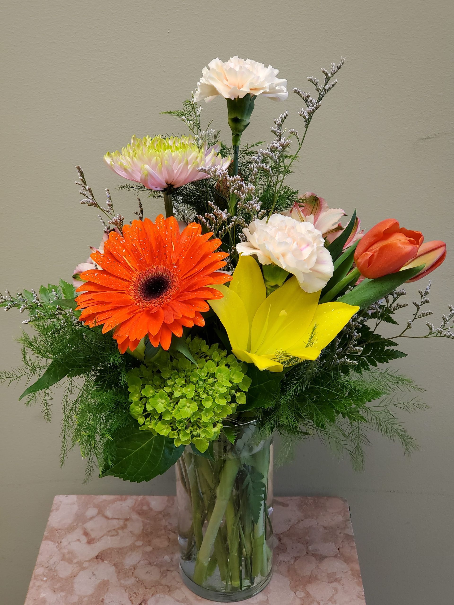 A vase filled with flowers is sitting on a table.