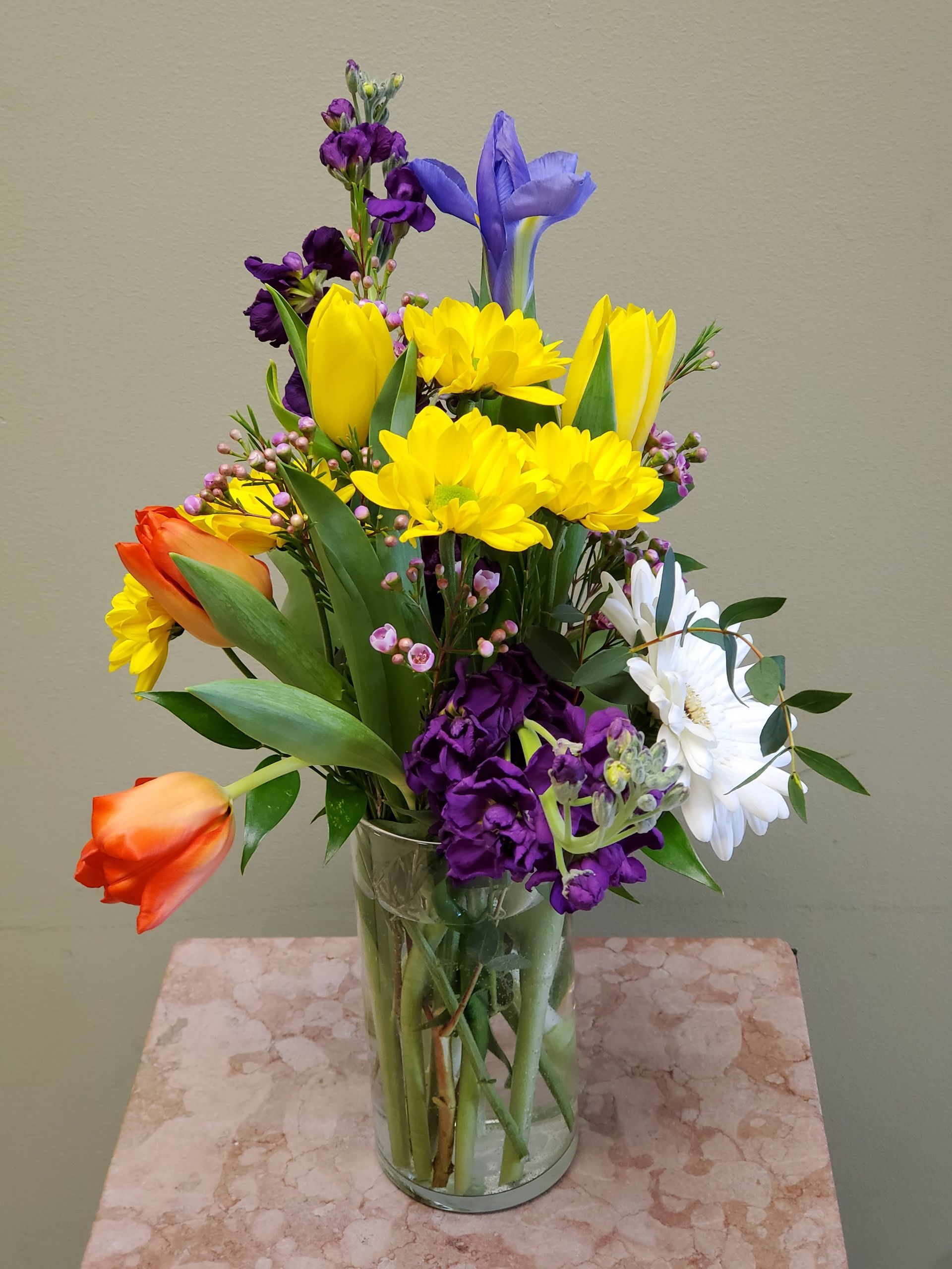A vase filled with flowers is sitting on a table.