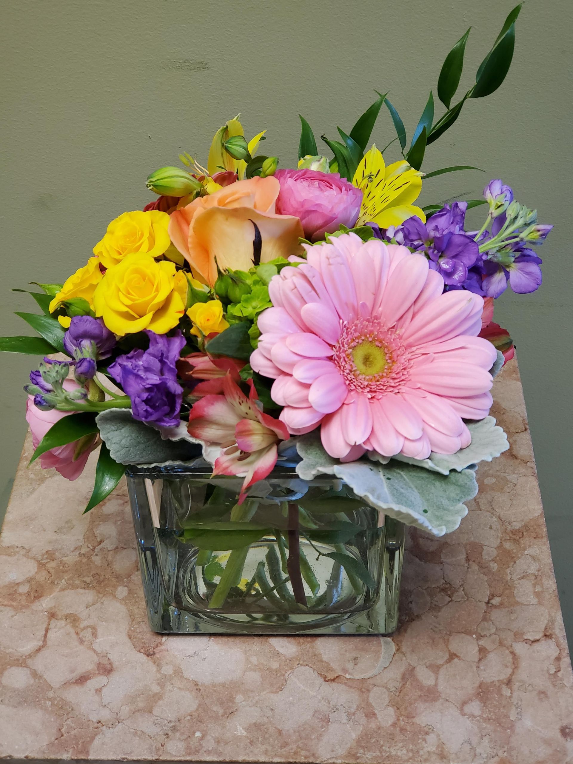 A vase filled with flowers is sitting on a table.