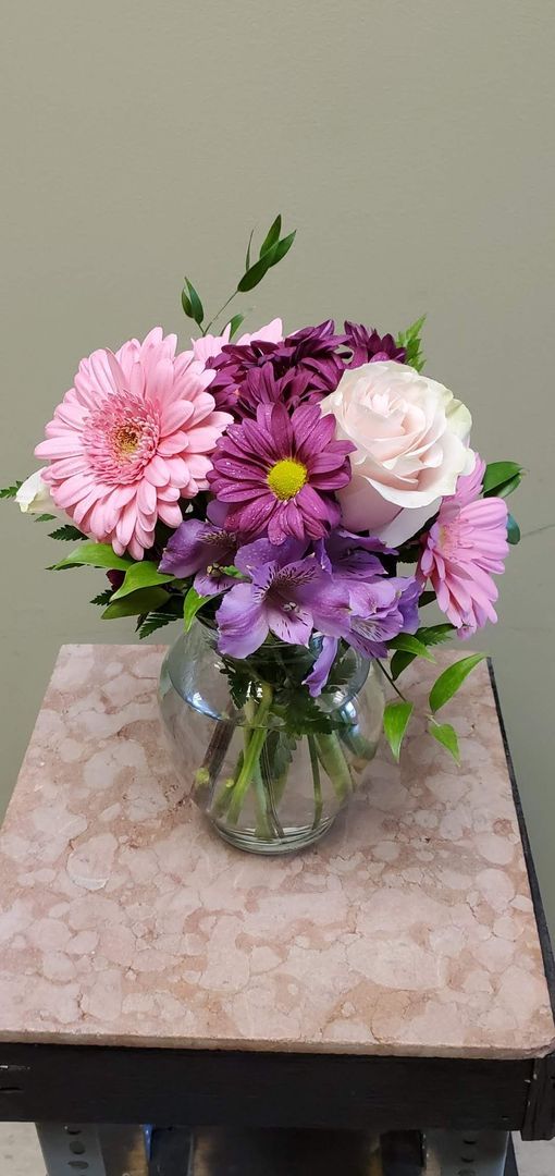 A vase filled with flowers is sitting on a table.