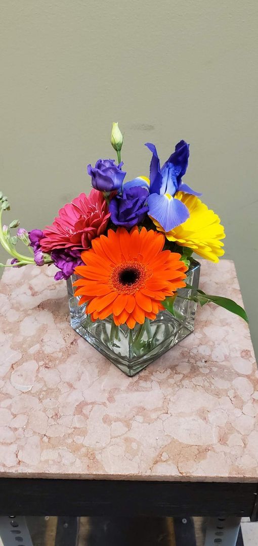 A vase filled with flowers is sitting on a table.
