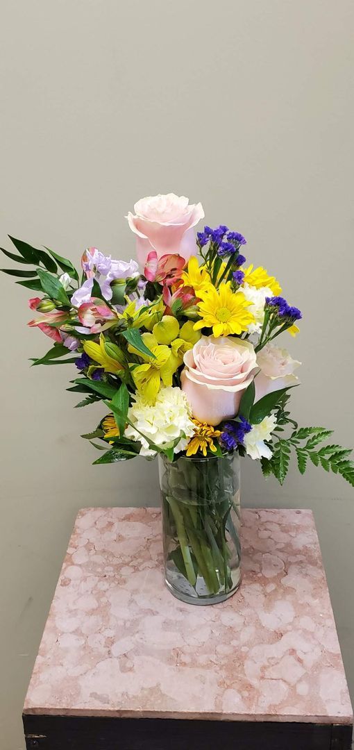 A vase filled with flowers is sitting on a table.
