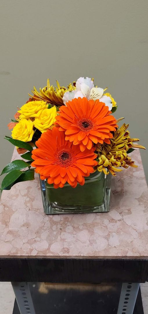 A vase filled with flowers is sitting on a table.