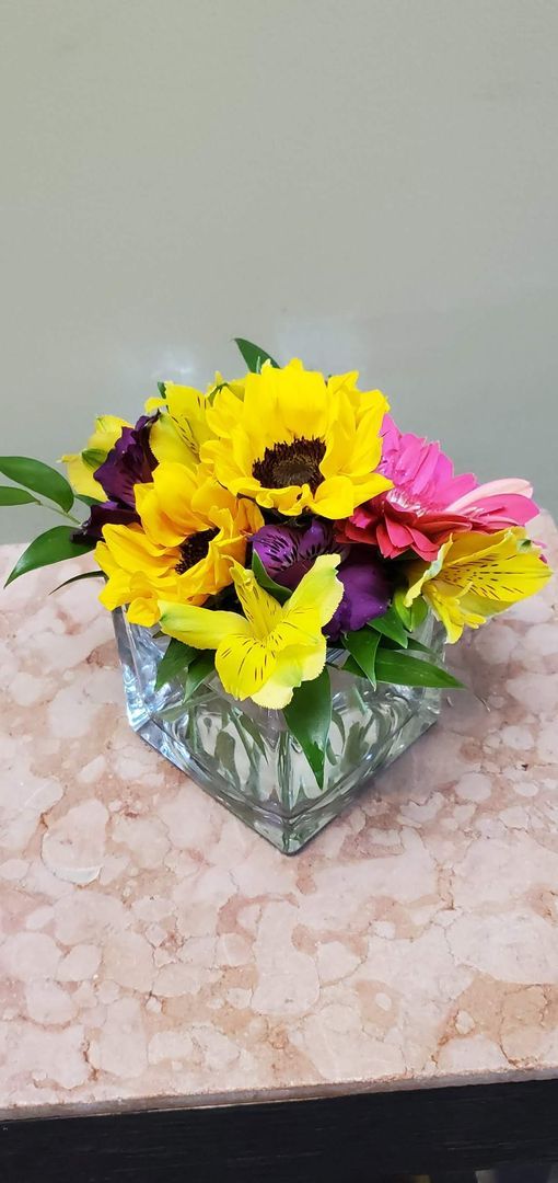 A vase filled with flowers is sitting on a table.