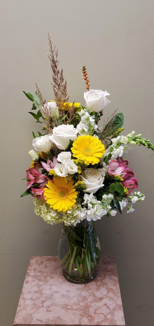 A vase filled with flowers is sitting on a table.