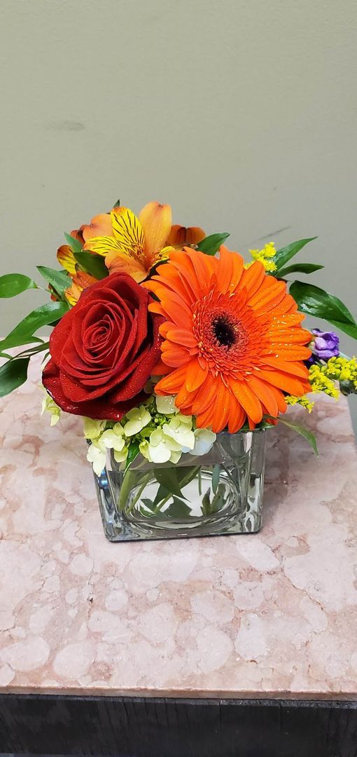 A vase filled with flowers is sitting on a table.