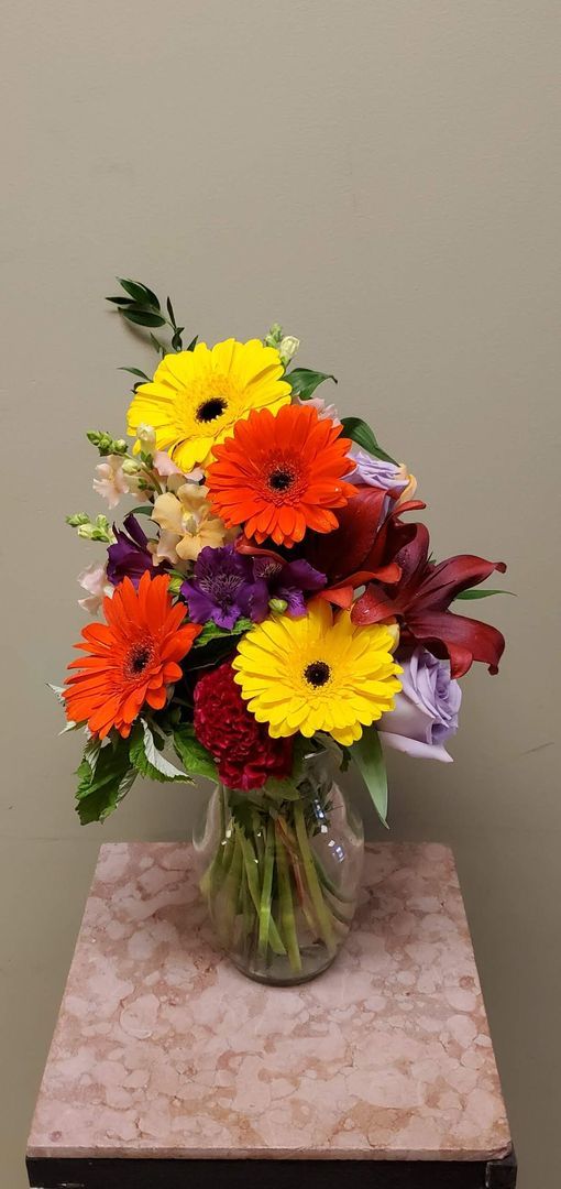 A vase filled with flowers is sitting on a table.