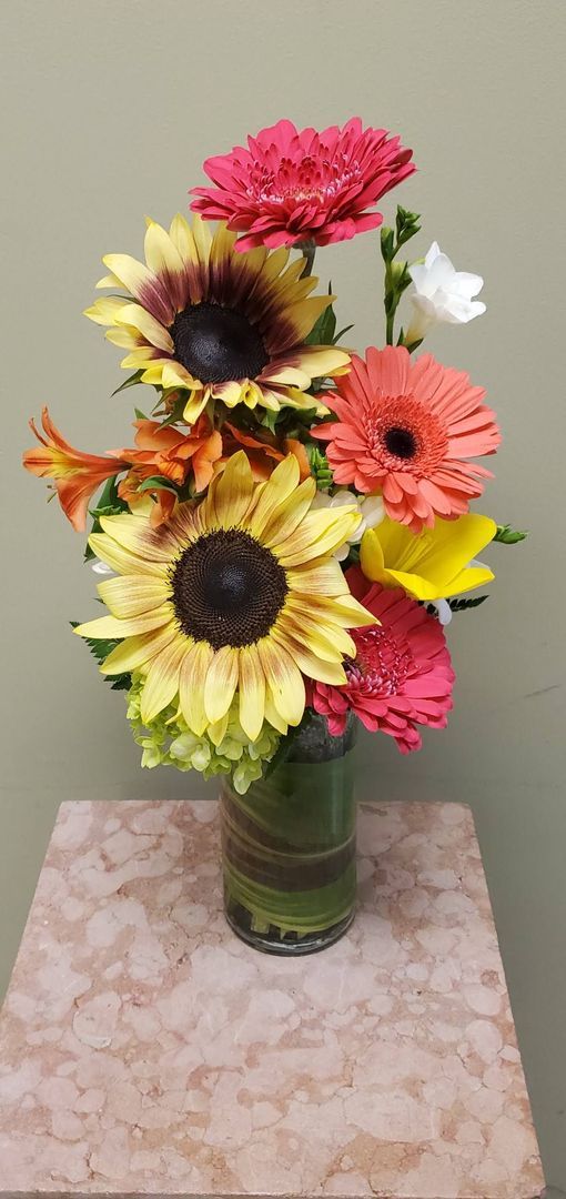 A vase filled with flowers is sitting on a table.