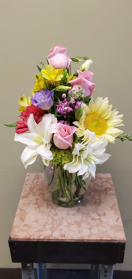 A vase filled with flowers is sitting on a table.