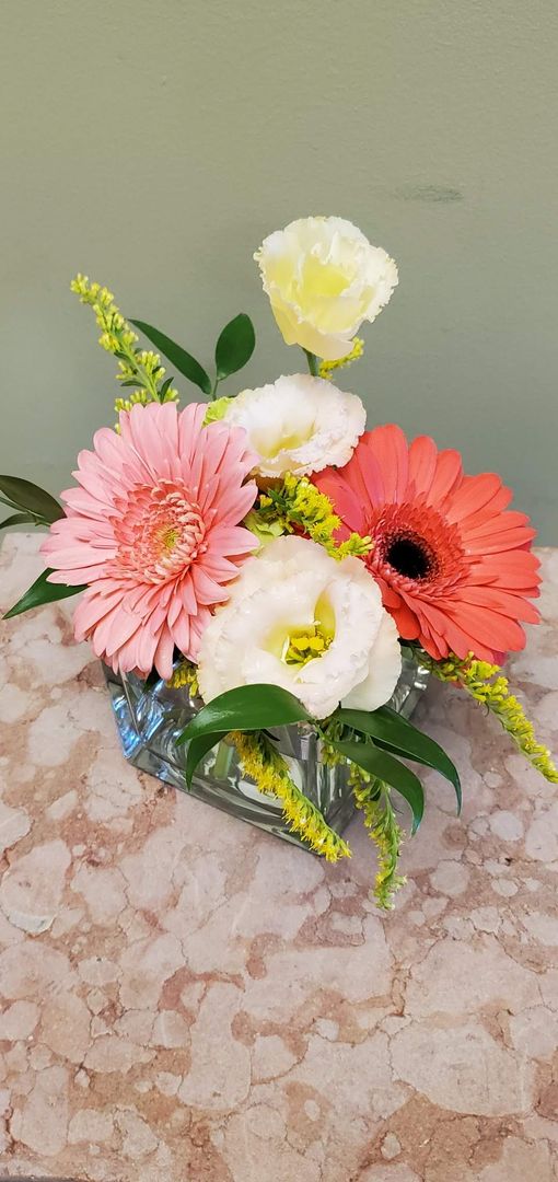 A vase filled with flowers is sitting on a table.