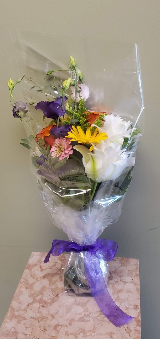 A vase filled with flowers is sitting on a table.