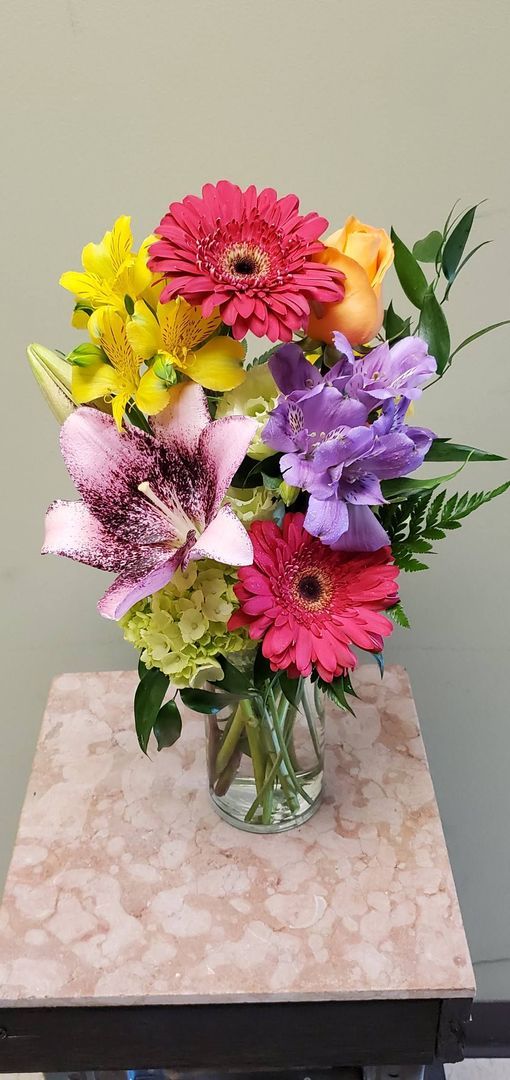 A vase filled with flowers is sitting on a table.