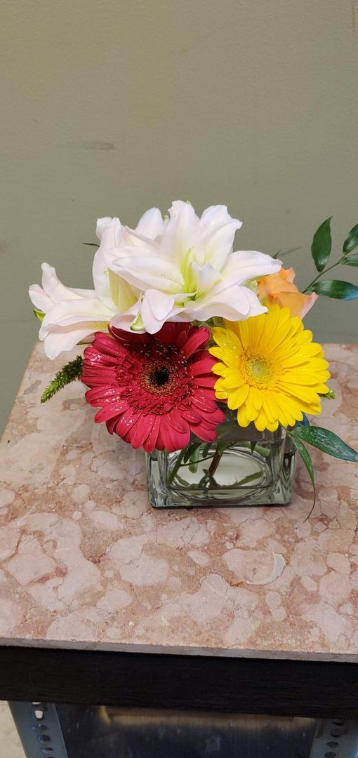 A vase filled with flowers is sitting on a table.