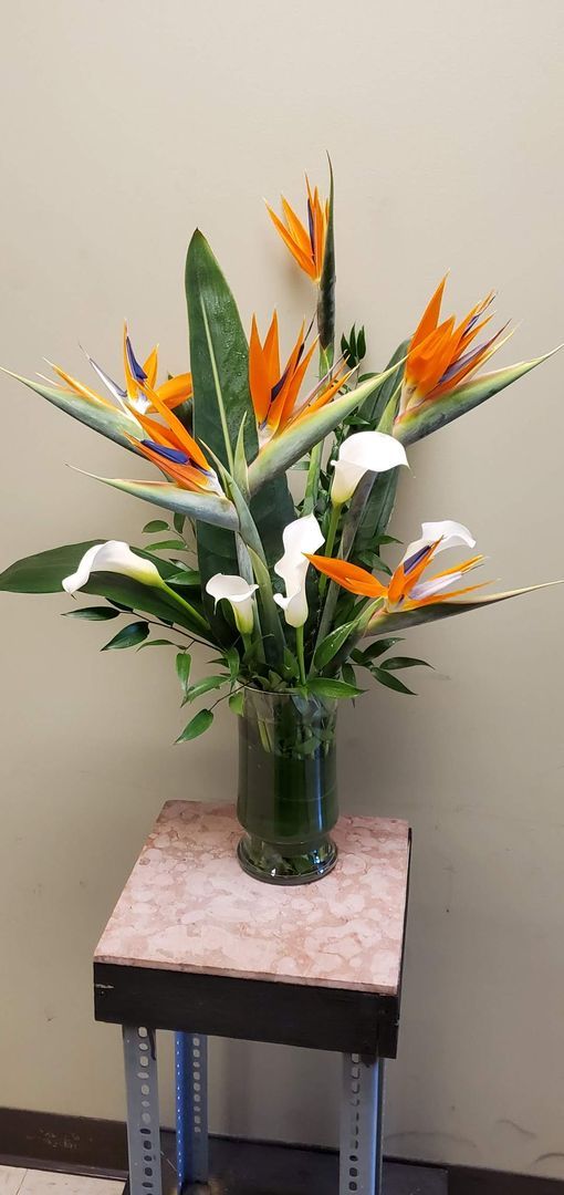 A vase filled with flowers is sitting on a table.