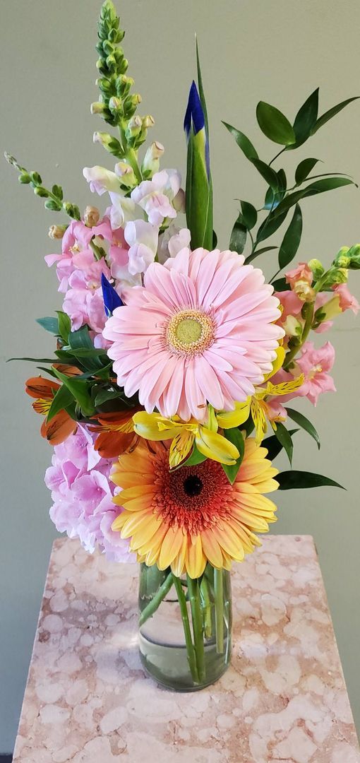 A vase filled with flowers is sitting on a table.