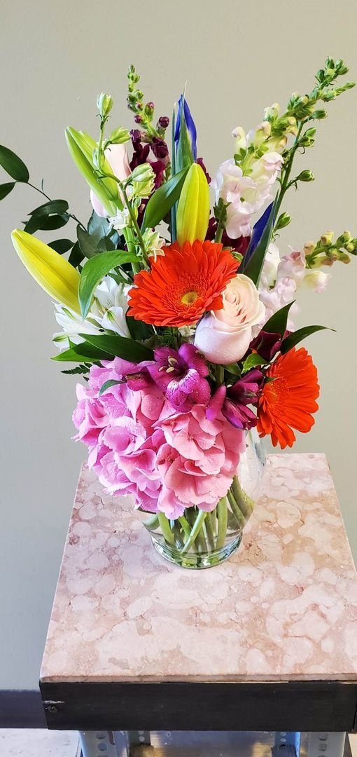 A vase filled with flowers is sitting on a table.