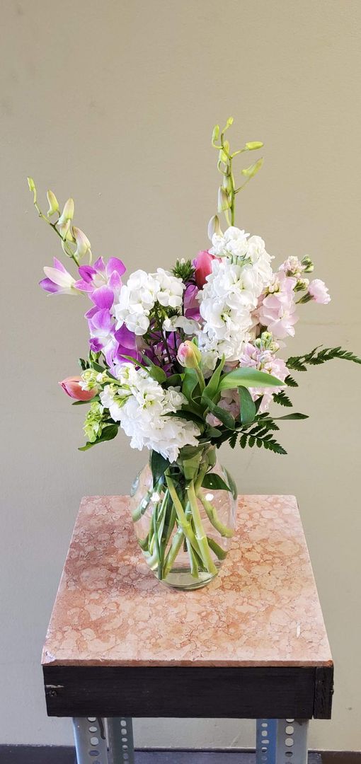 A vase filled with flowers is sitting on a table.