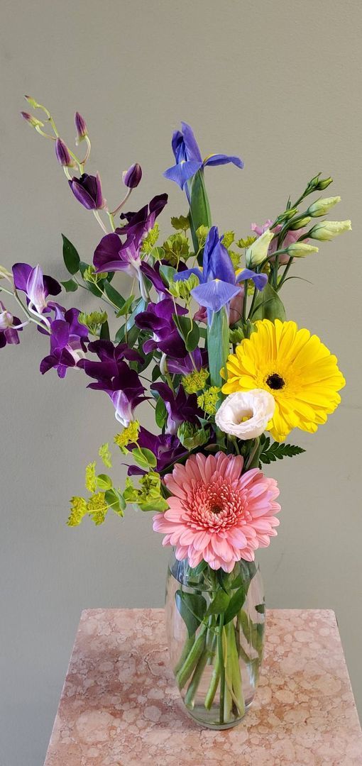 A vase filled with flowers is sitting on a table.